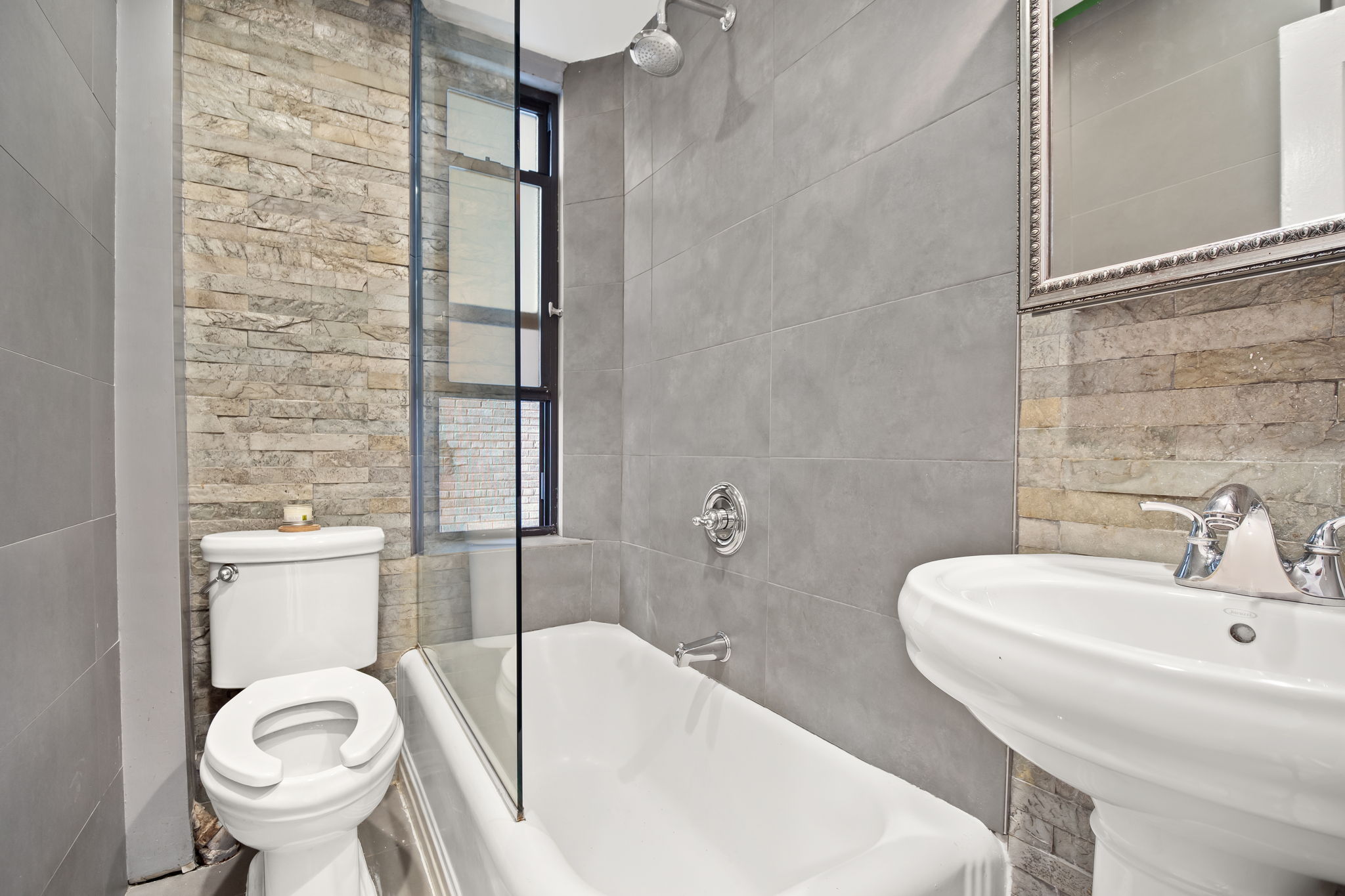 305 West 72nd Street, Unit 7D Manhattan, NY 10023 - Photo 5 of 12 a bathroom with a sink a toilet and shower