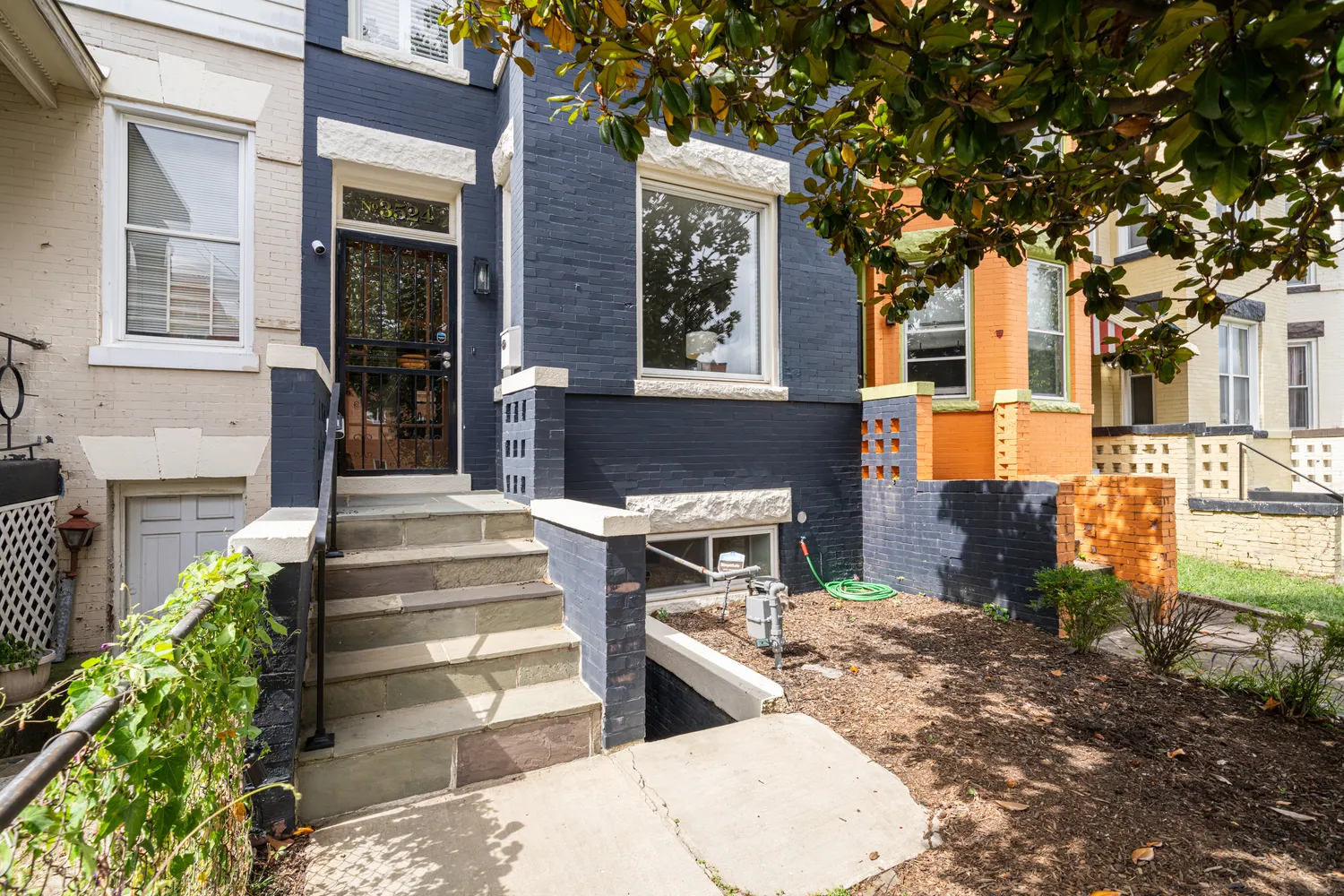 a front view of a house with a garden