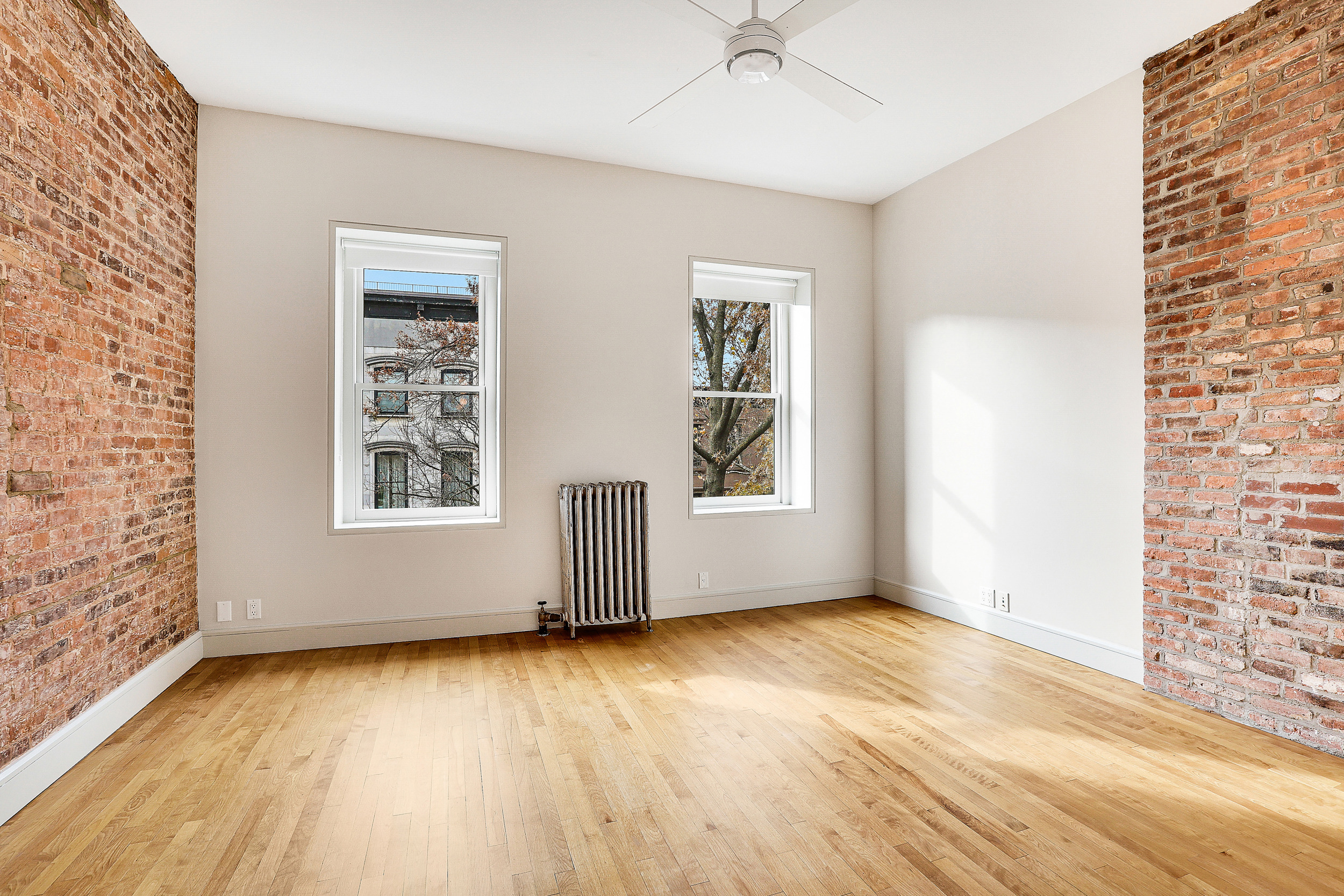 187 President Street, Unit 2 Brooklyn, NY 11231 - Photo 13 of 17 a view of an empty room with a window and wooden floor