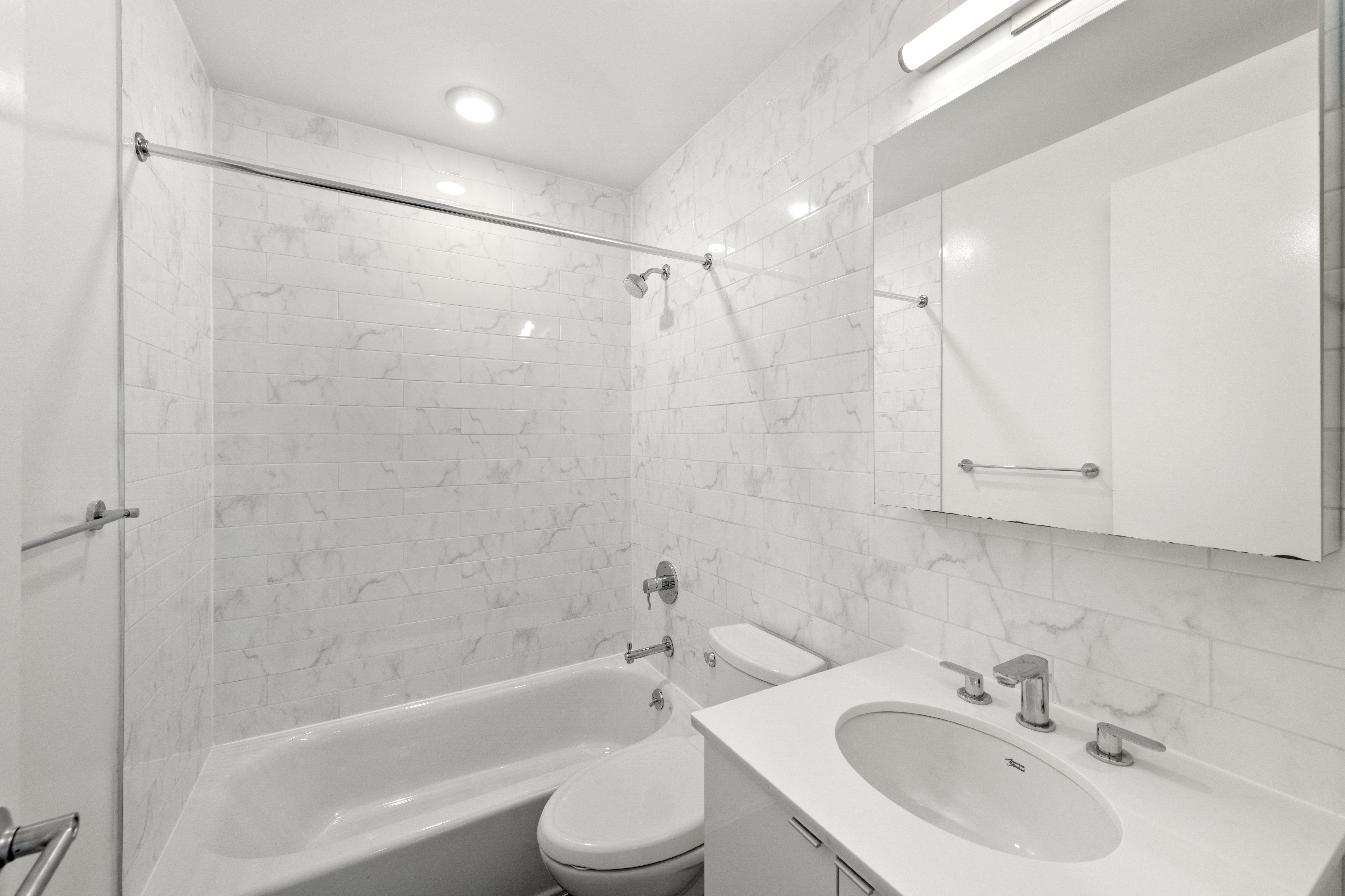 1164 Greene Avenue, Unit PHB Brooklyn, NY 11221 - Photo 9 of 16 a bathroom with a bathtub shower sink vanity and toilet