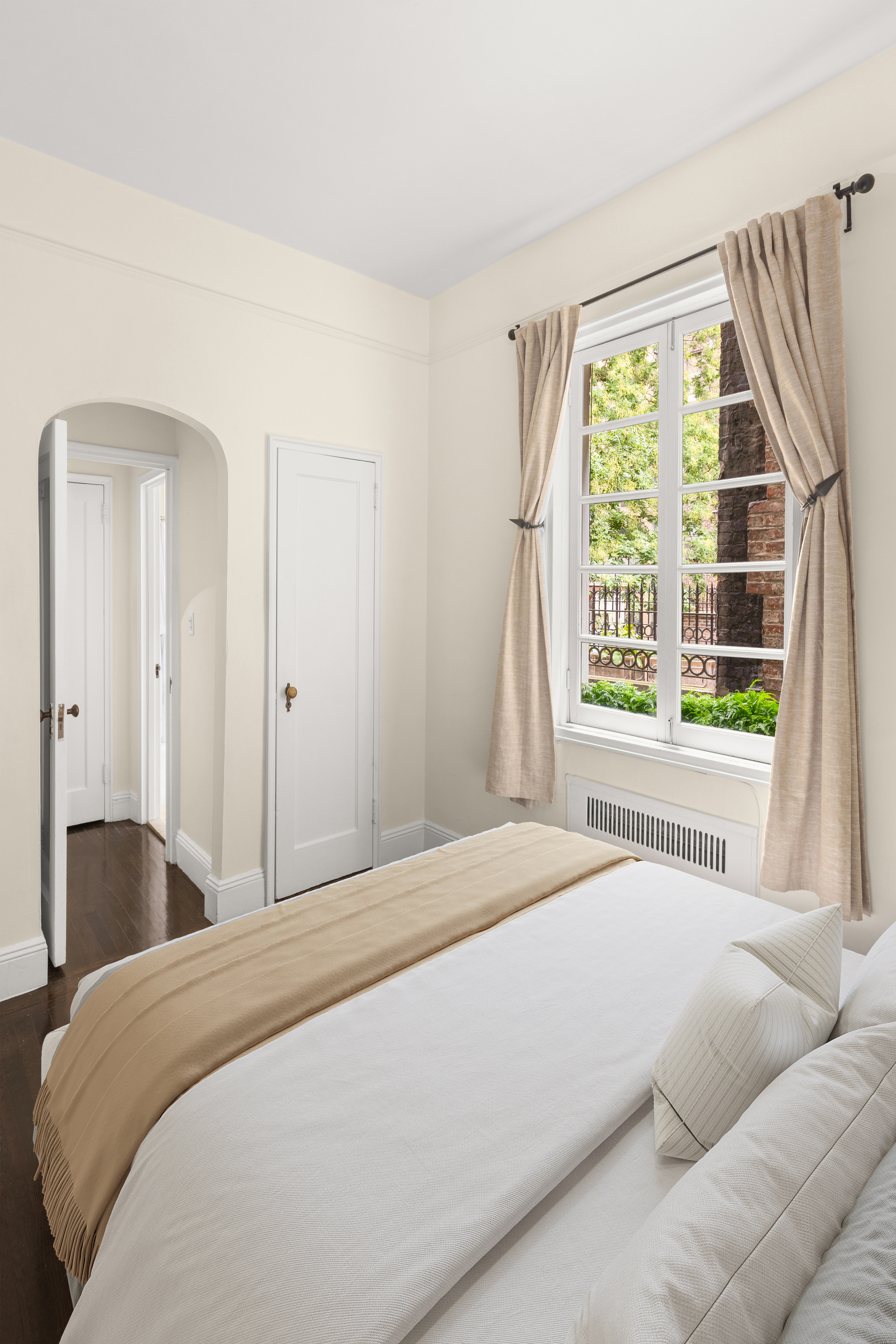 51 East 78th Street, Unit 3BC Manhattan, NY 10075 - Photo 13 of 25 a bedroom with a bed and a large window