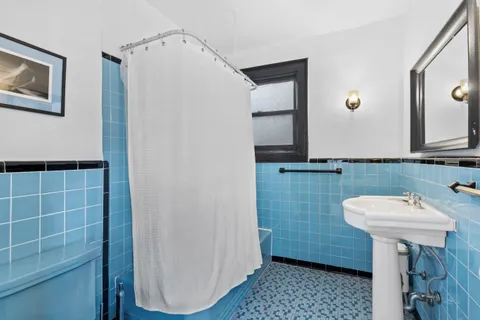a bathroom with a sink a mirror and a toilet
