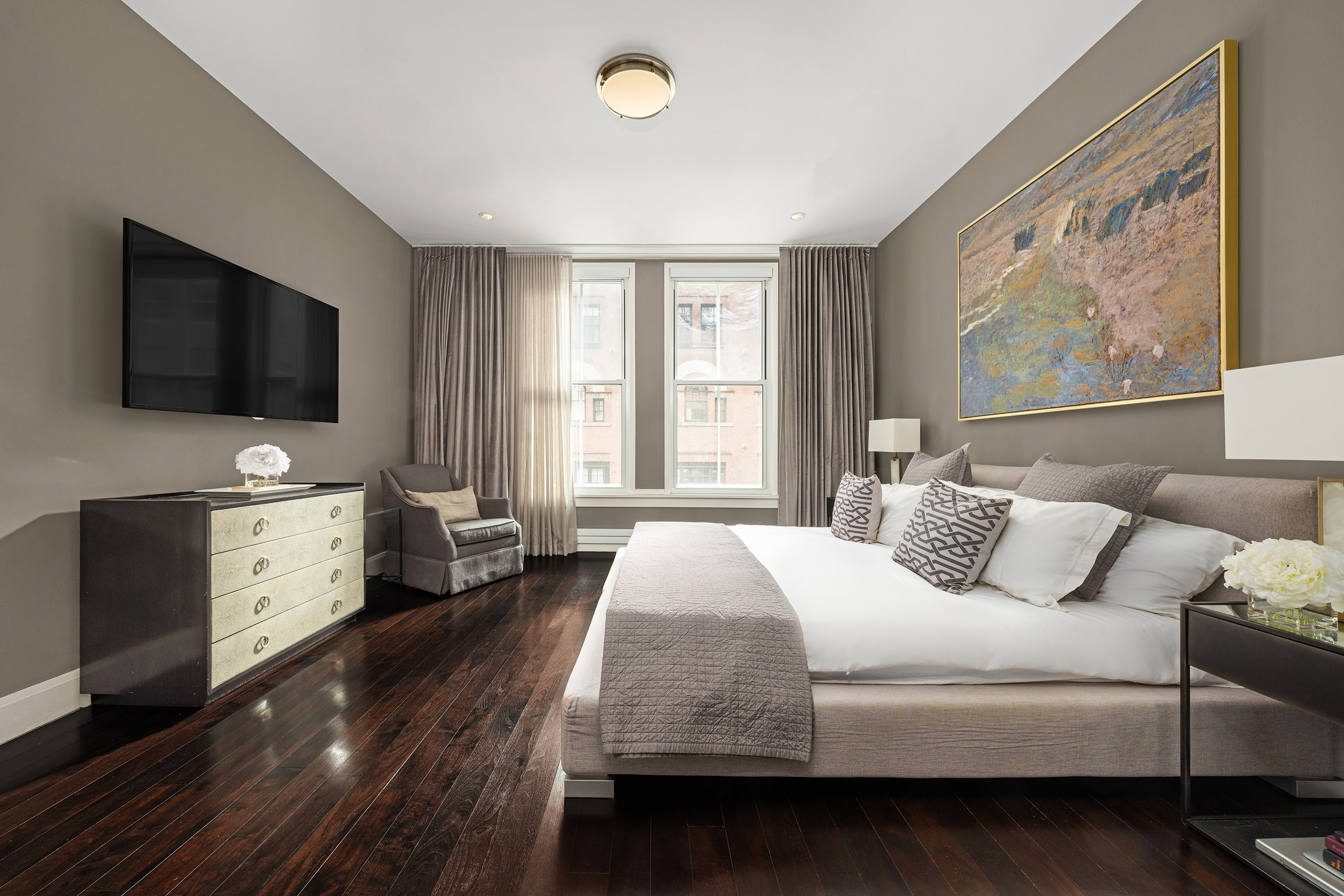 52 Laight Street, Unit R2 Manhattan, NY 10013 - Photo 10 of 21 a bedroom with a bed and a flat screen tv