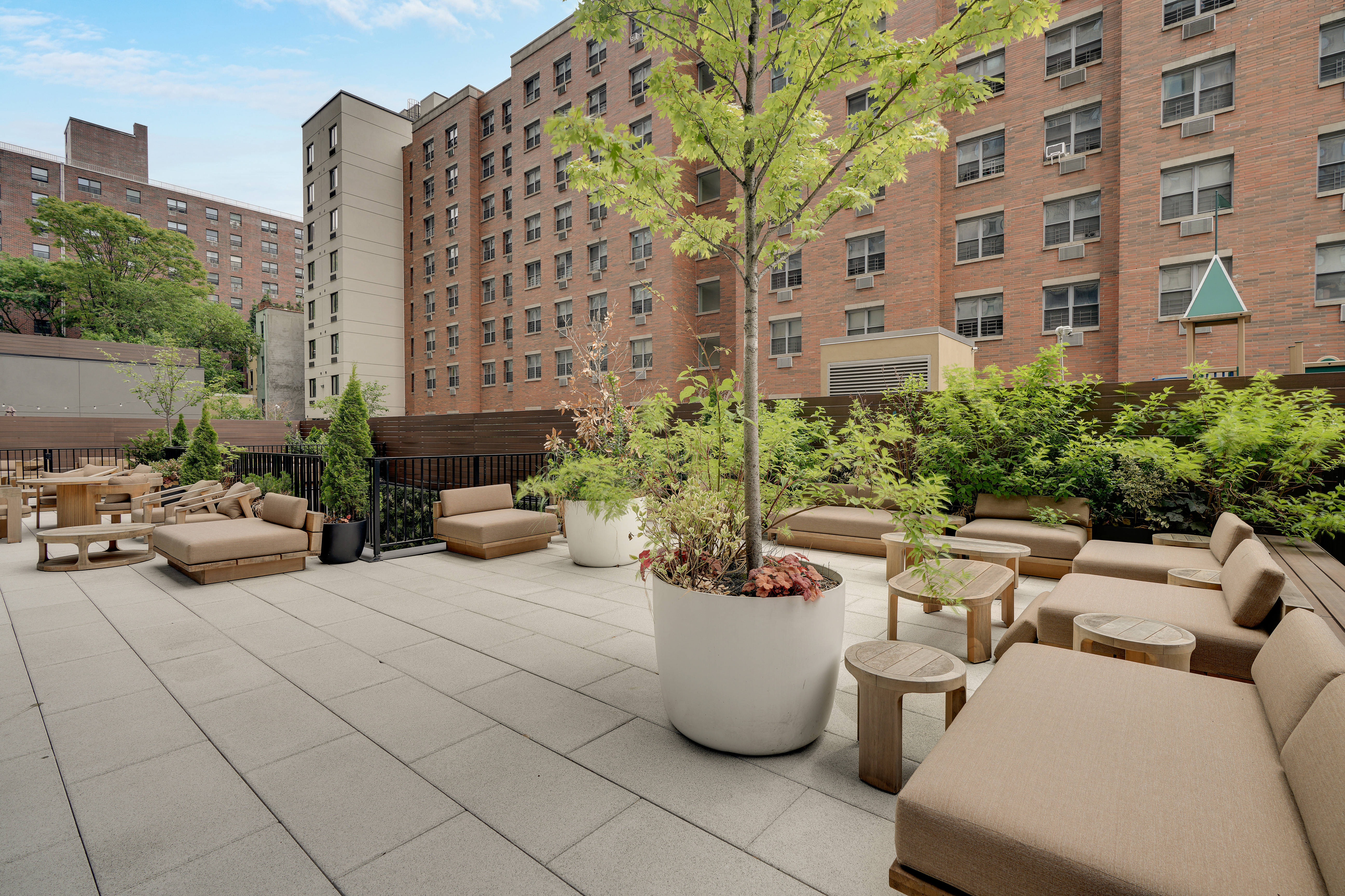 224 West 124th Street, Unit 305 Manhattan, NY 10027 - Photo 19 of 23 a view of a patio with couches and a potted plant