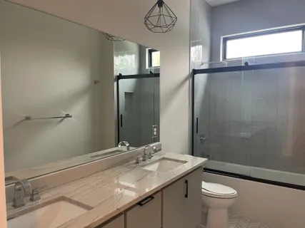 a bathroom with a bathtub and a shower