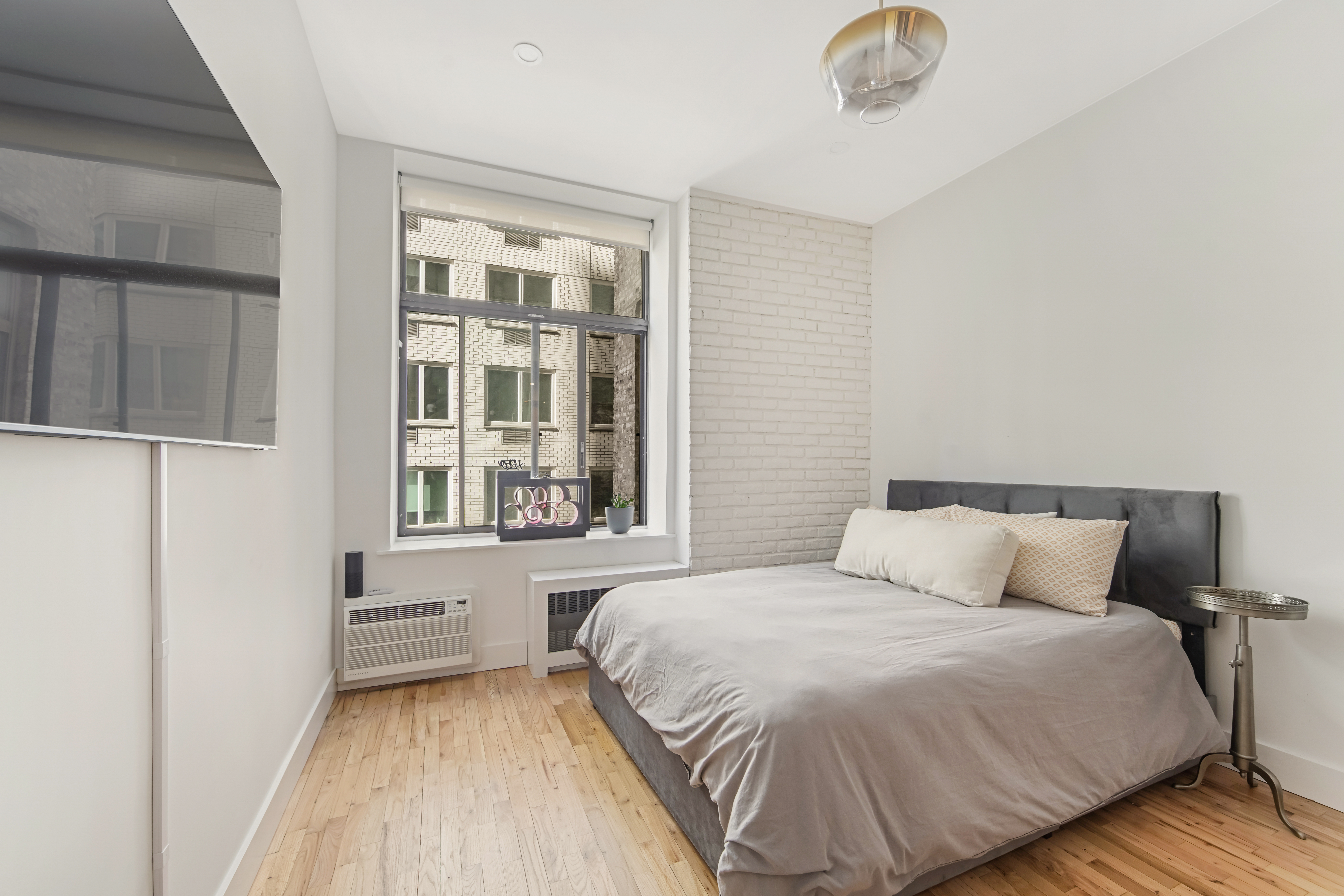 310 East 23rd Street, Unit 3B Manhattan, NY 10010 - Photo 4 of 11 a bedroom with a bed and a window