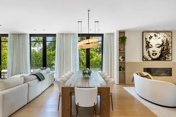a living room with furniture and large windows