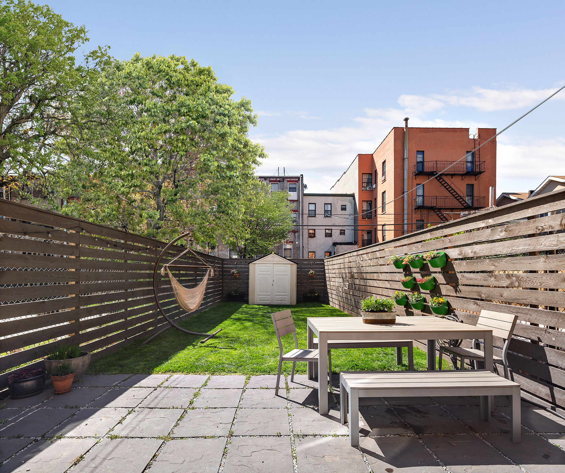 232 Monroe Street Brooklyn, NY 11216 - Photo 13 of 21 a view of a chairs and table in a patio