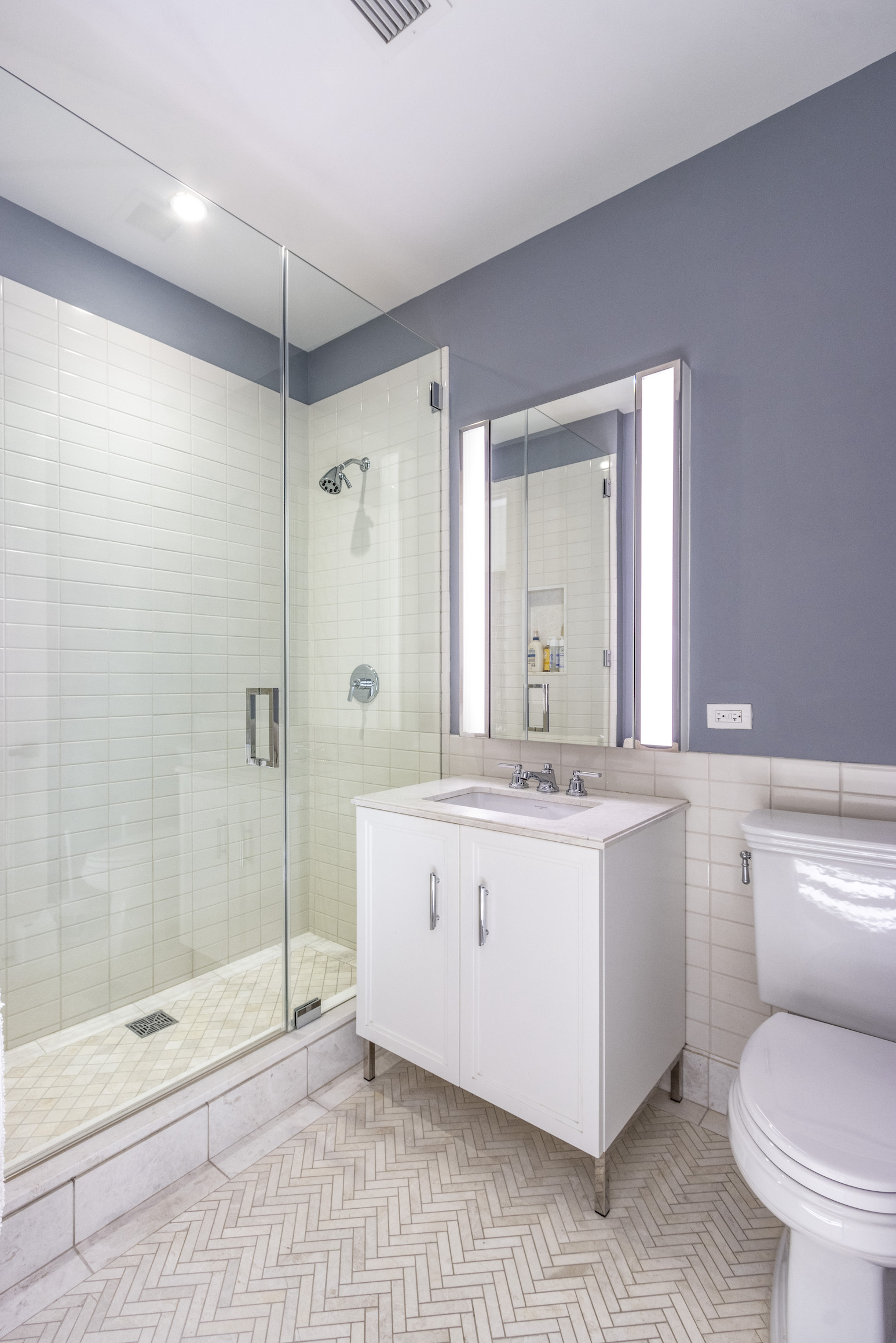 100 Barclay Street, Unit 15P Manhattan, NY 10007 - Photo 22 of 34 a spacious bathroom with a shower sink mirror and a toilet