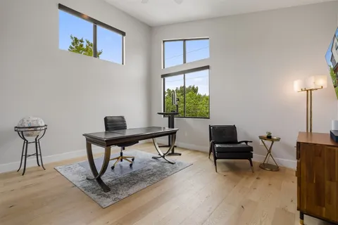 a view of a livingroom with furniture and floor to ceiling window