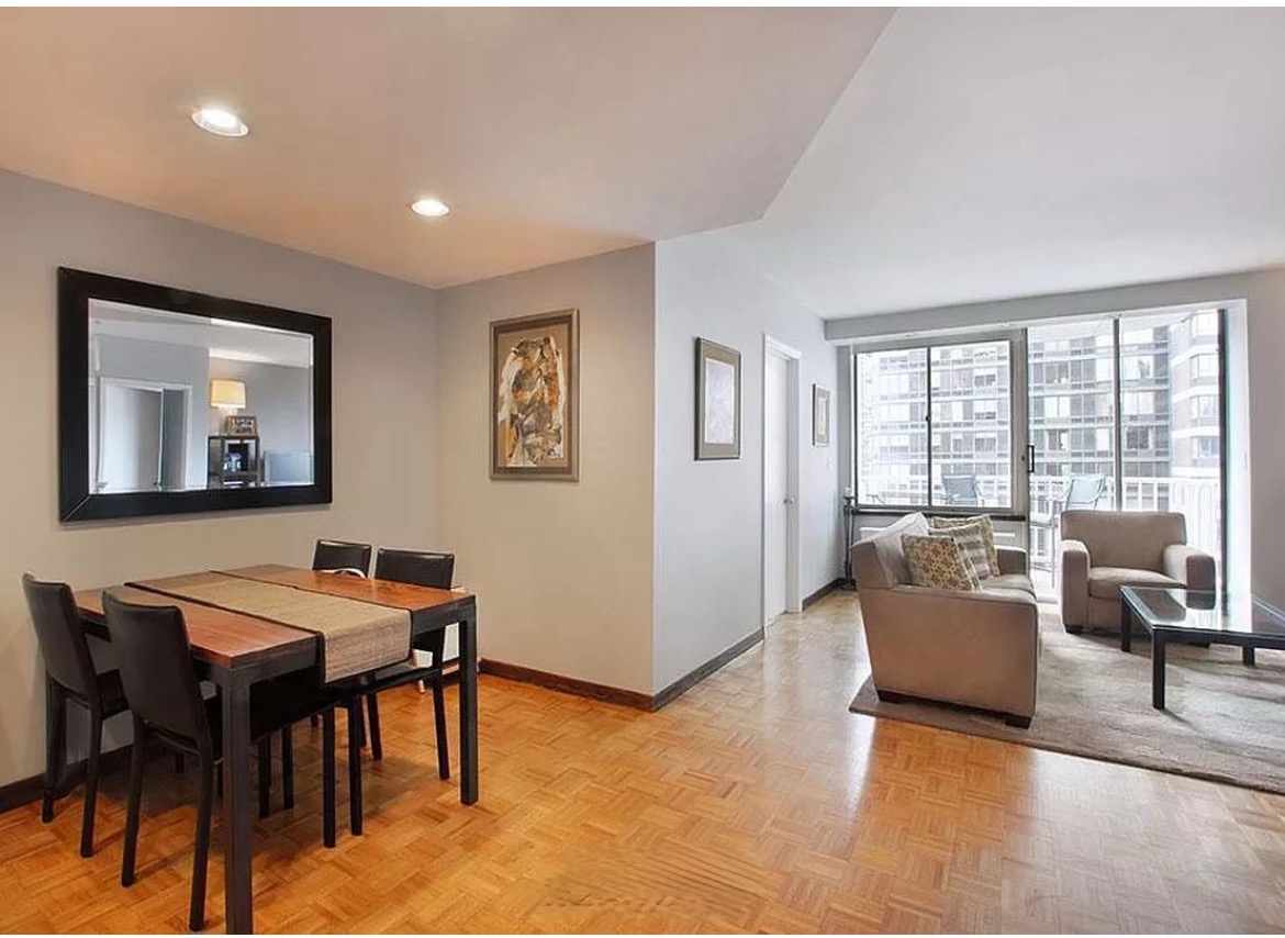 a living room with furniture and large windows