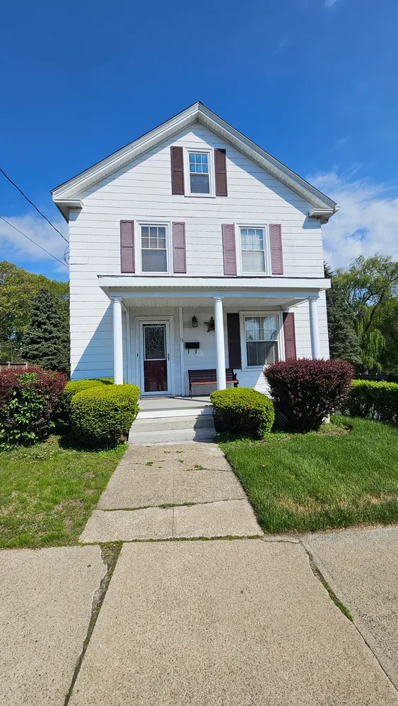 a front view of a house with a yard