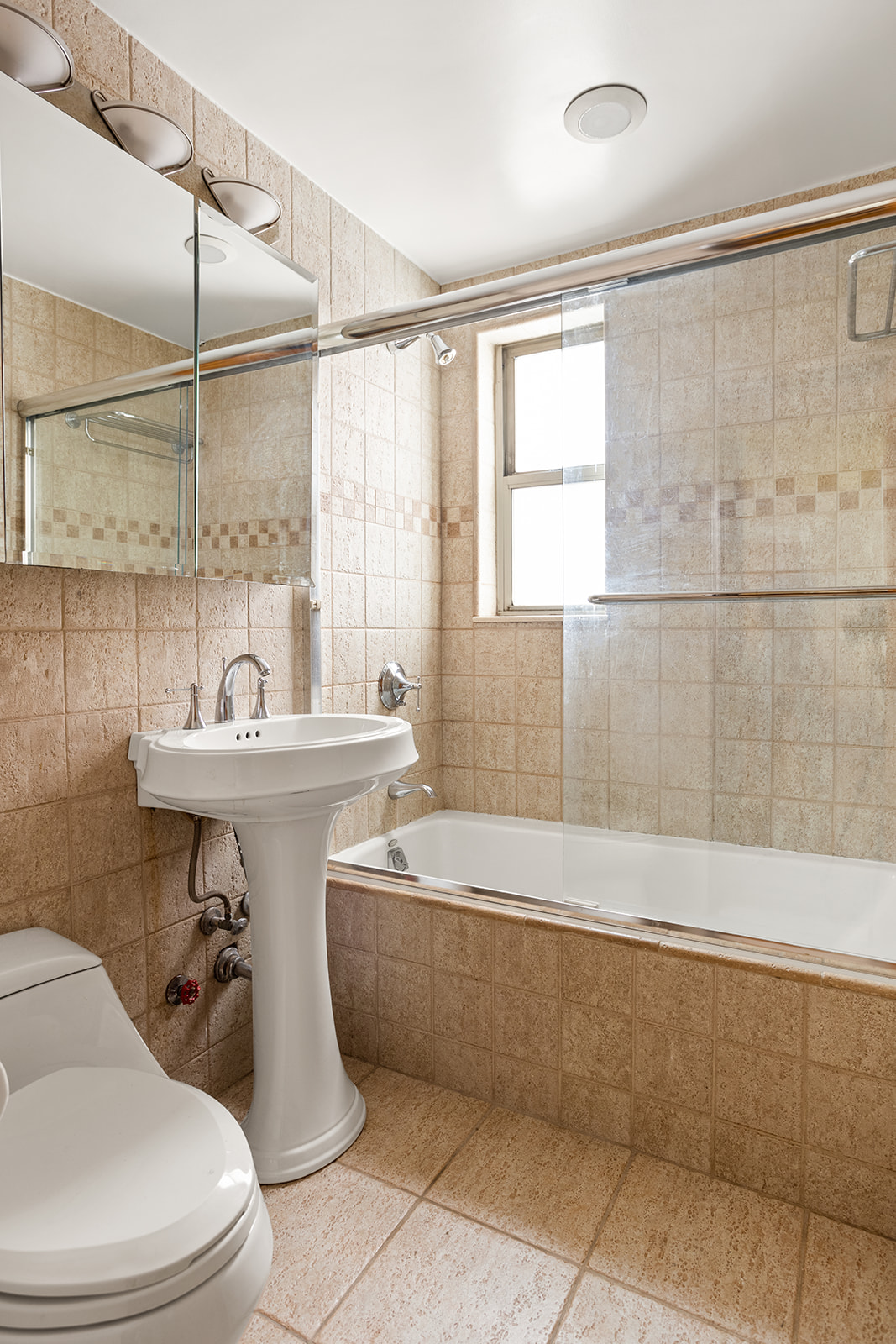 79-10 34th Avenue, Unit 2G Queens, NY 11372 - Photo 7 of 11 a bathroom with a sink toilet and shower