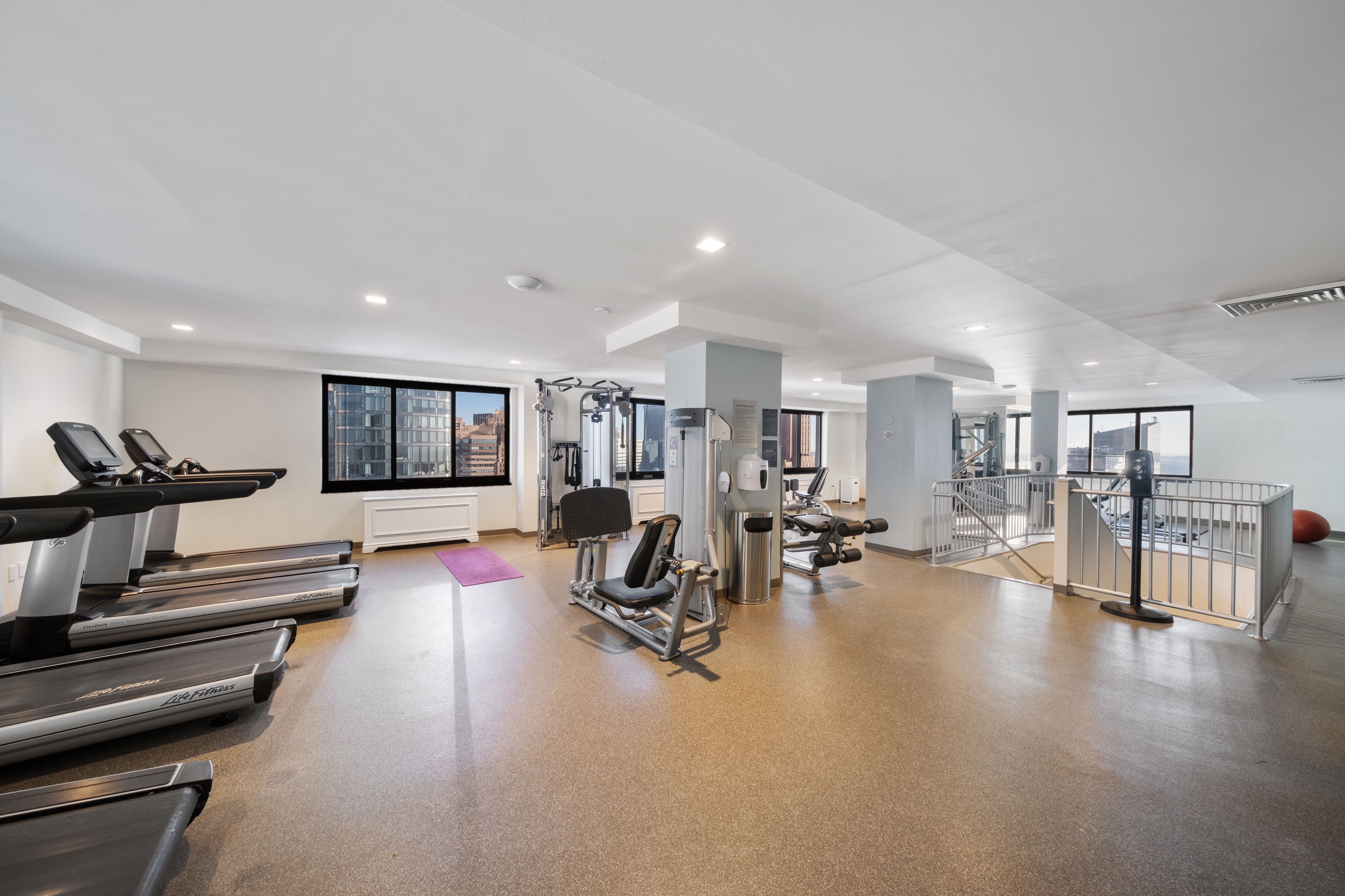 200 Rector Place, Unit 16F Manhattan, NY 10280 - Photo 10 of 25 a view of a room with gym equipment and a large window