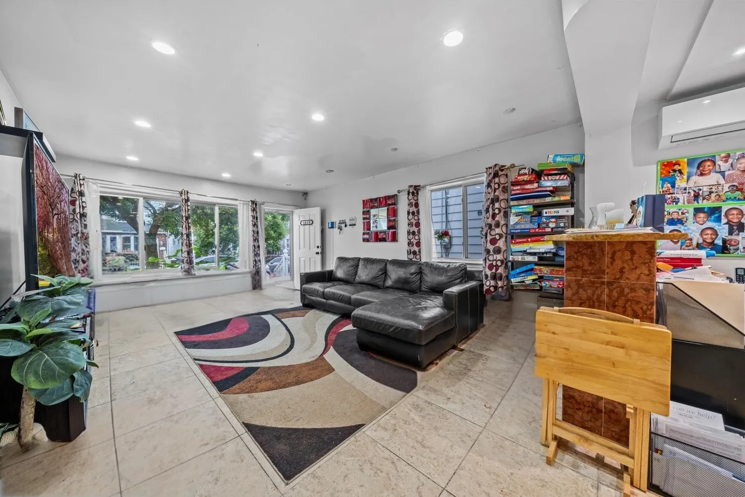 a living room with furniture and a potted plant