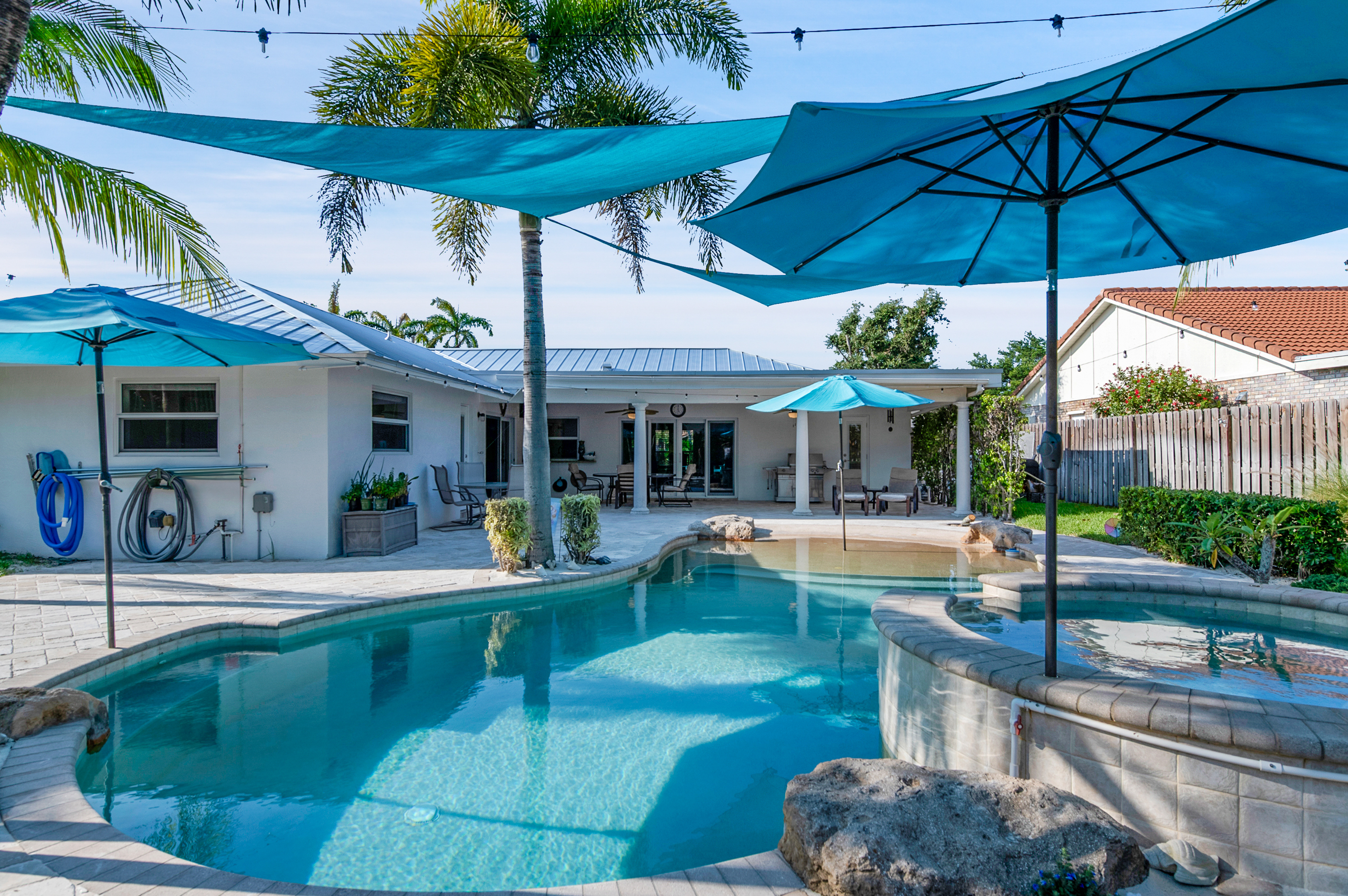 1560 Southwest 16th Street Boca Raton, FL 33486 - Photo 16 of 72 a view of a patio with table and chairs under an umbrella