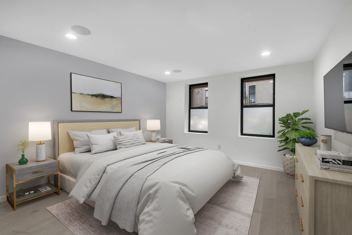 208 West 122nd Street Manhattan, NY 10027 - Photo 18 of 22 a bedroom with a large bed and potted plant