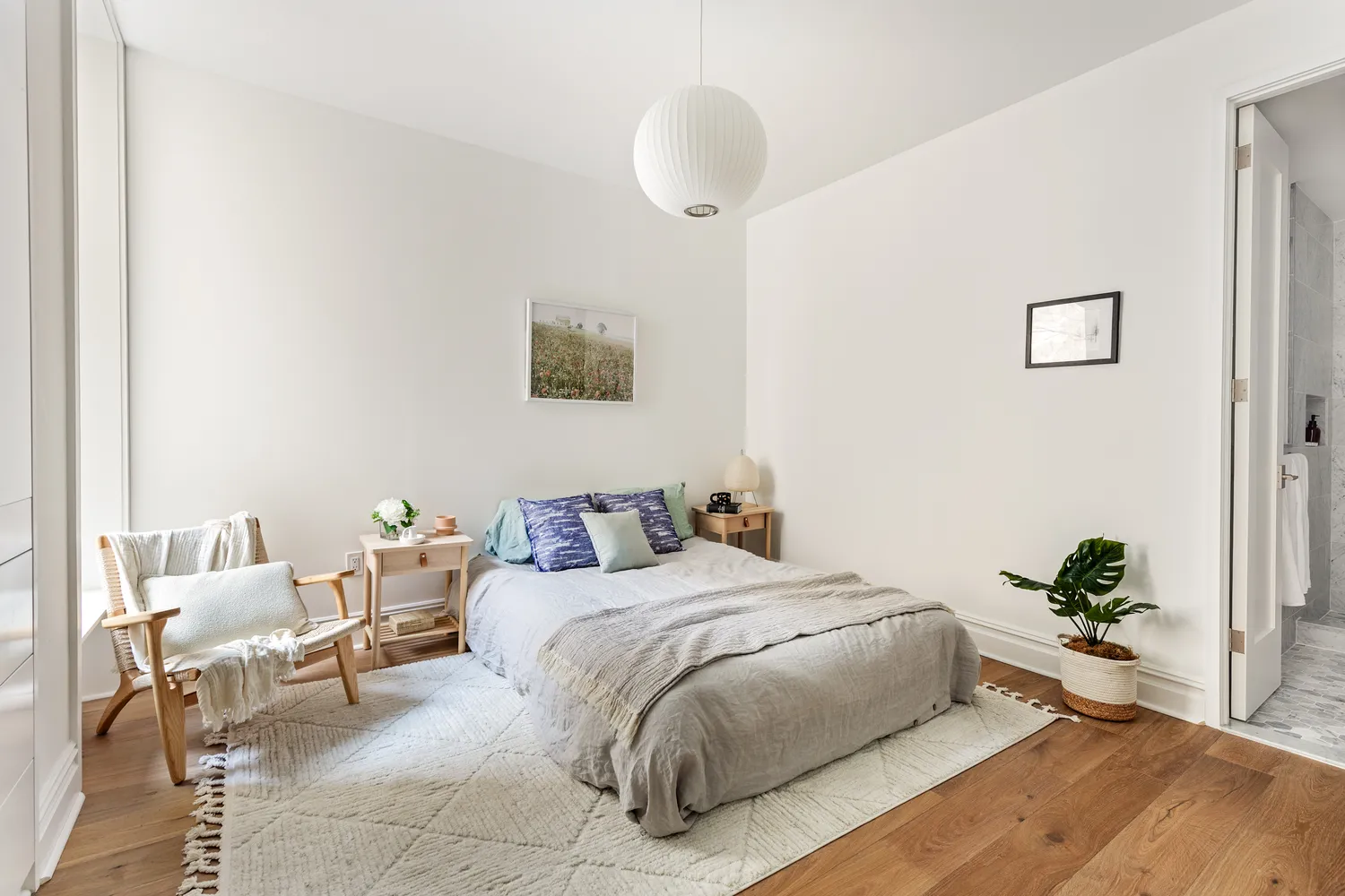 a bedroom with a bed and a potted plant