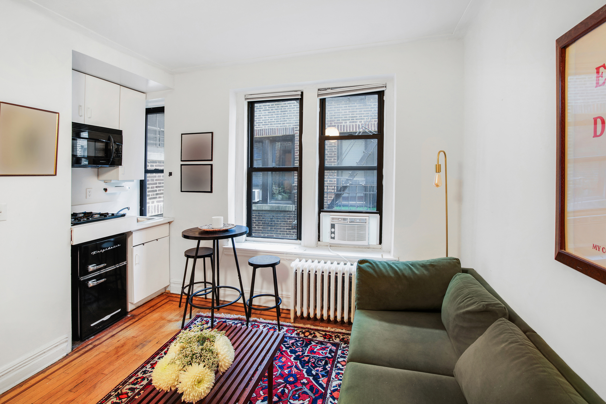 300 8th Avenue, Unit 5G Brooklyn, NY 11215 - Photo 2 of 8 a living room with furniture and a flat screen tv