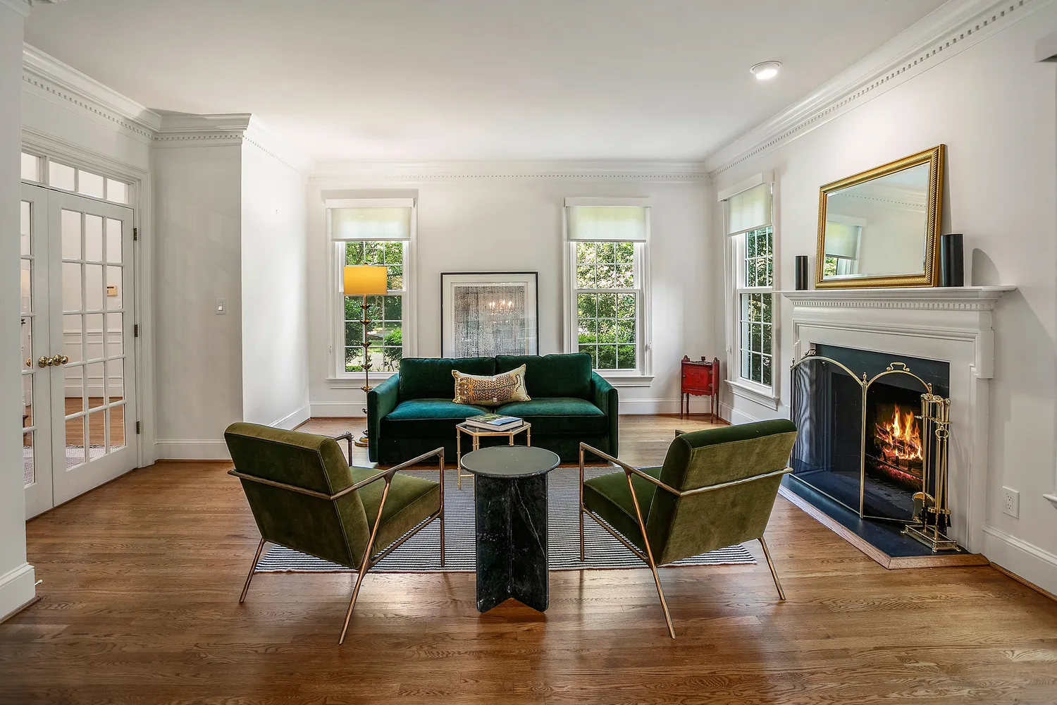 a living room with fireplace furniture and a wooden floor
