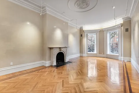 a view of empty room with a fireplace and fan