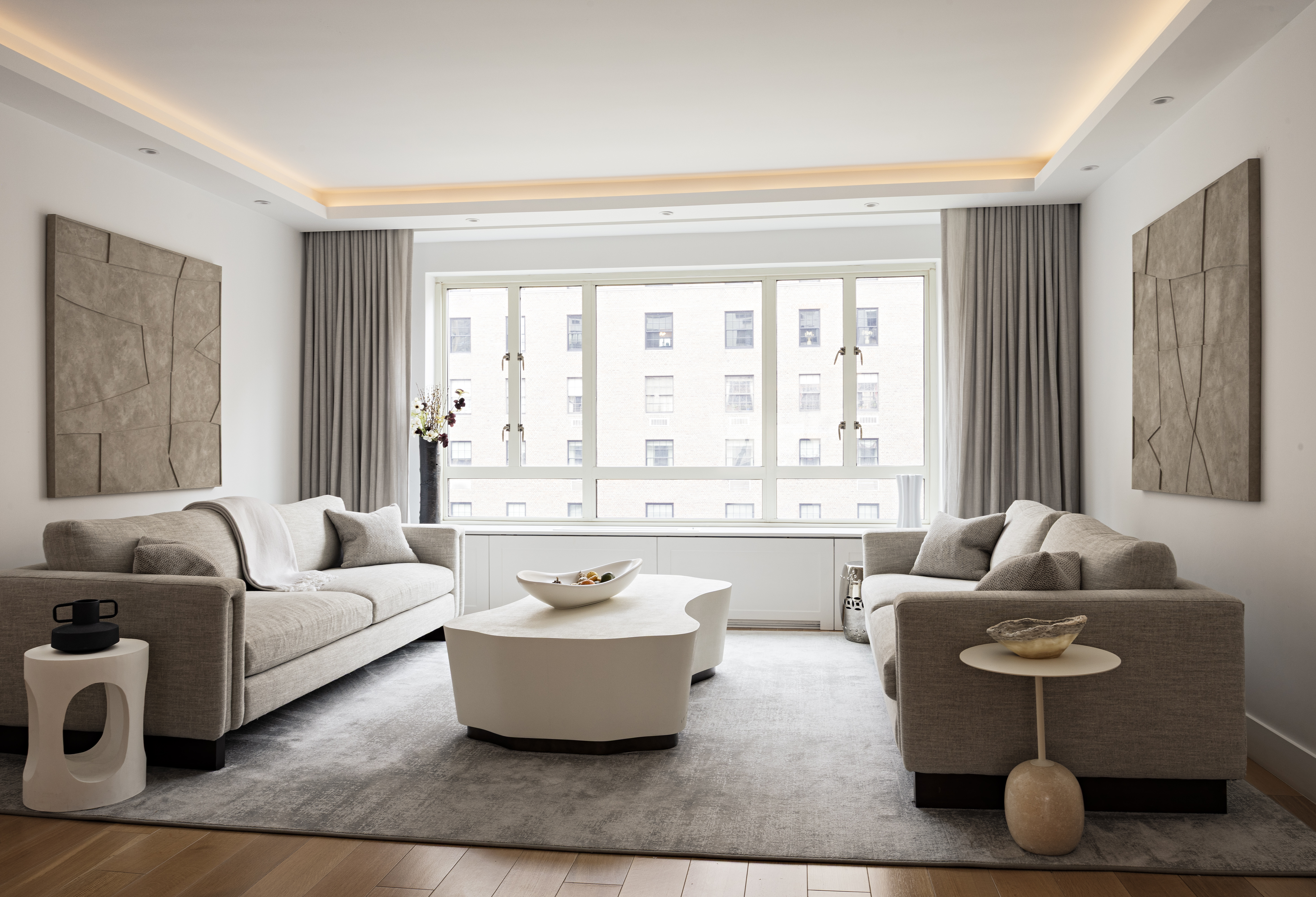799 Park Avenue, Unit 10A Manhattan, NY 10021 - Photo 2 of 12 a living room with furniture and floor to ceiling windows