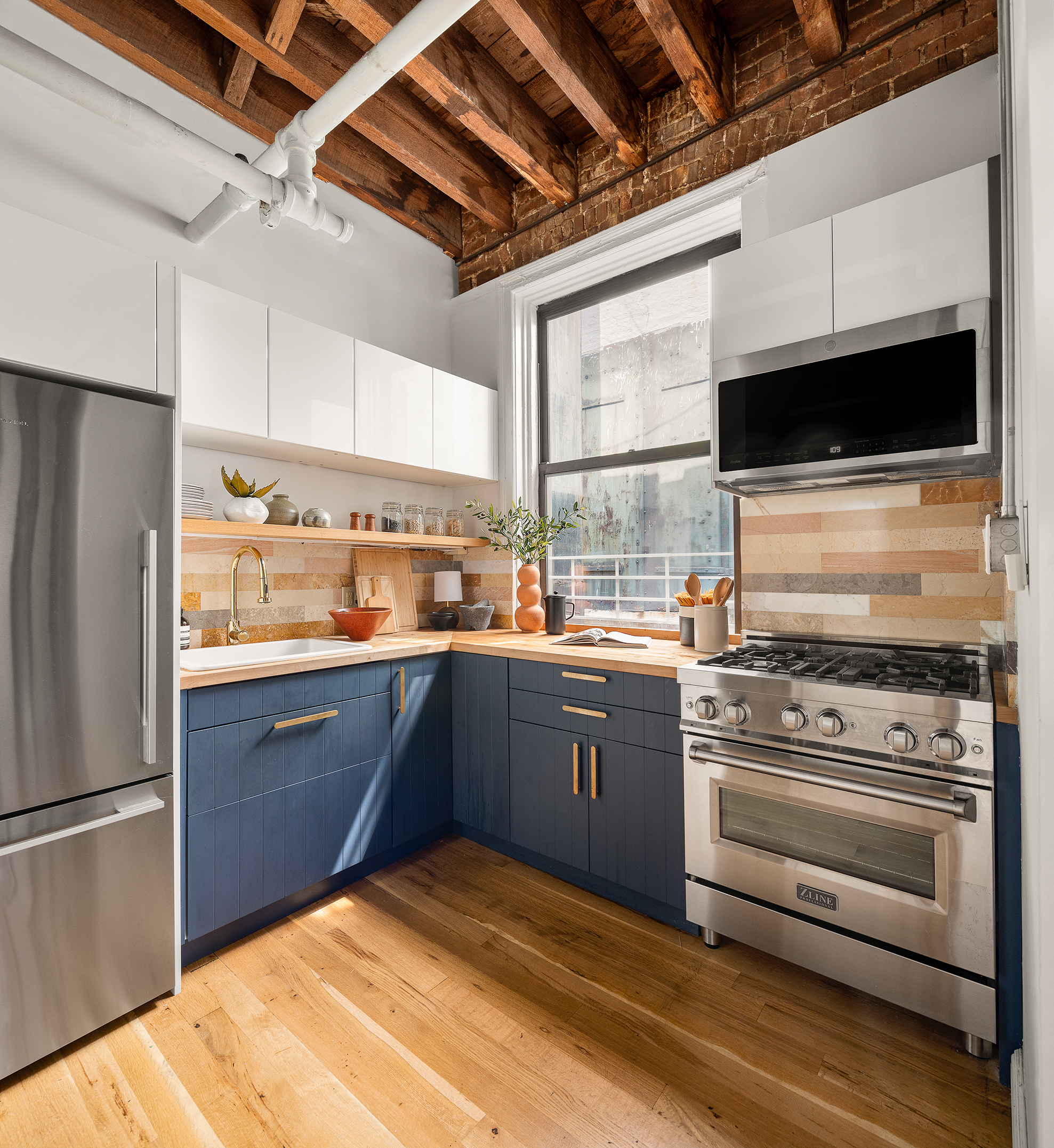 84 Forsyth Street, Unit 5R Manhattan, NY 10002 - Photo 7 of 14 a kitchen with a stove a refrigerator and a wooden floor