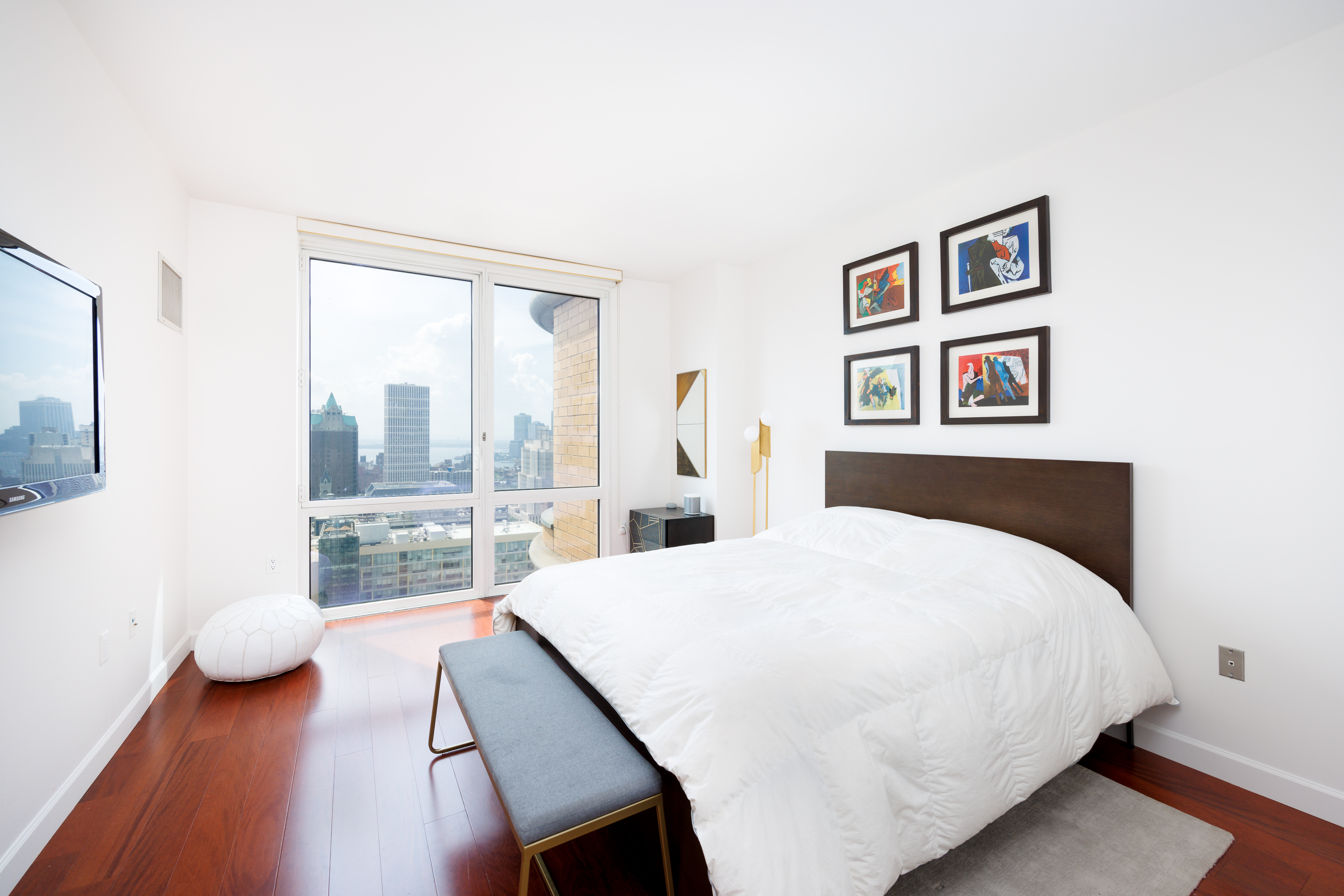 306 Gold Street, Unit 33E Brooklyn, NY 11201 - Photo 5 of 8 a bedroom with a bed and a large window