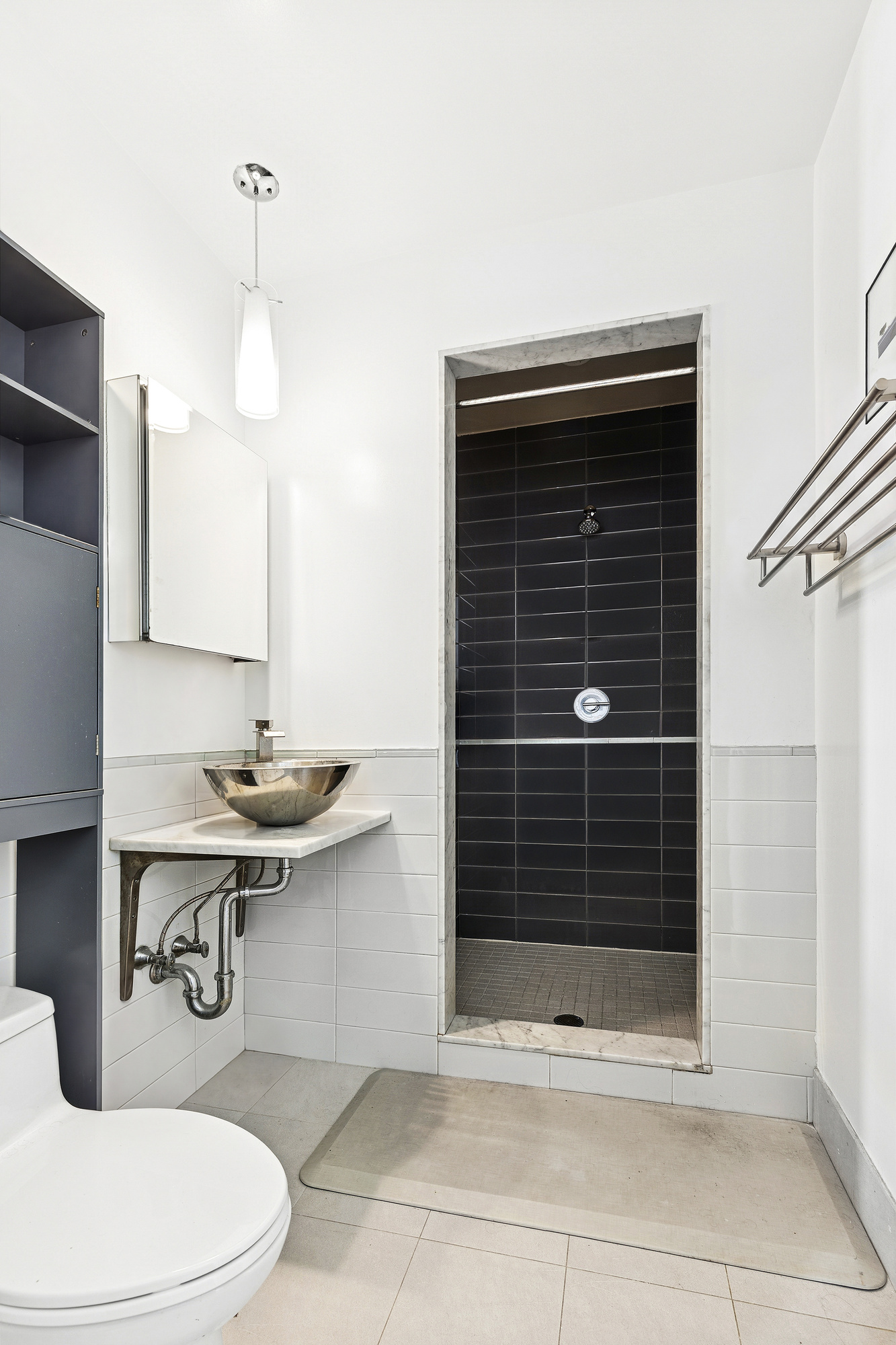 78 Roebling Street, Unit 2B Brooklyn, NY 11211 - Photo 4 of 7 a bathroom with a sink a toilet and shower