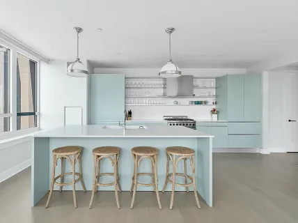 a kitchen with kitchen island granite countertop a sink a stove a table and chairs
