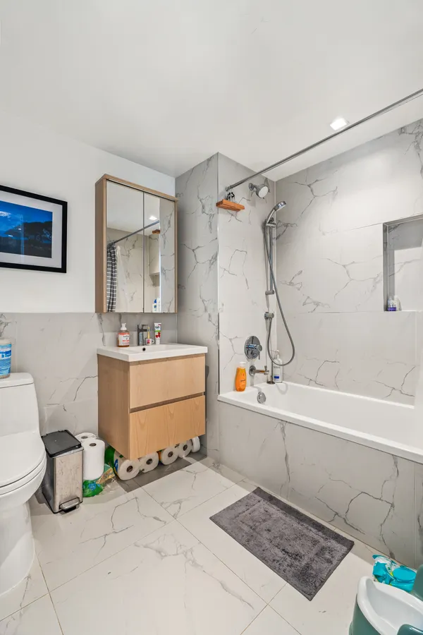 a bathroom with a sink mirror vanity and toilet