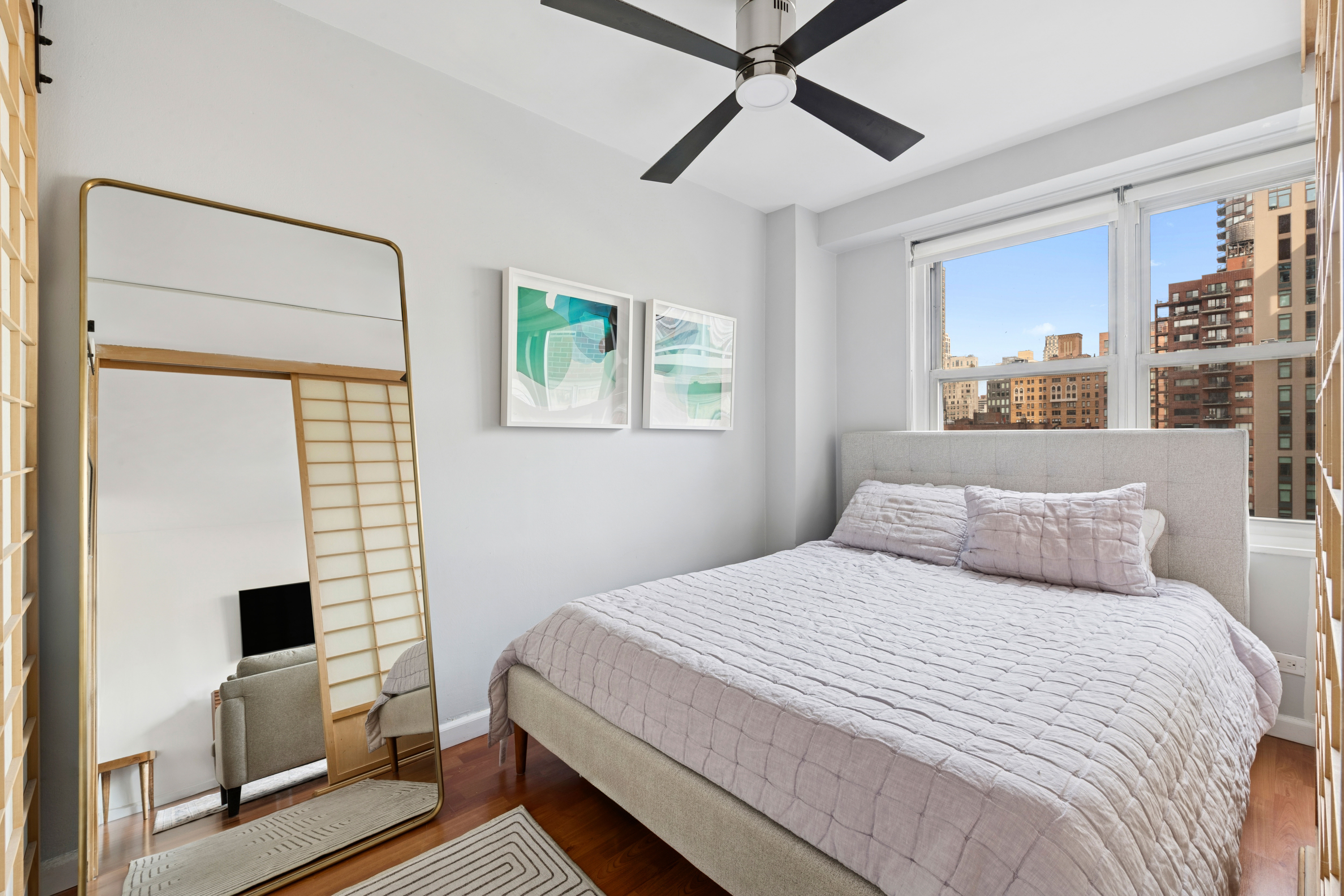 363 East 76th Street, Unit 11K Manhattan, NY 10021 - Photo 8 of 16 a bedroom with a large bed and a window
