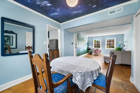 a dining room with furniture and wooden floor