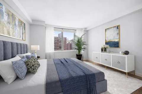 a bedroom with a large bed and a window