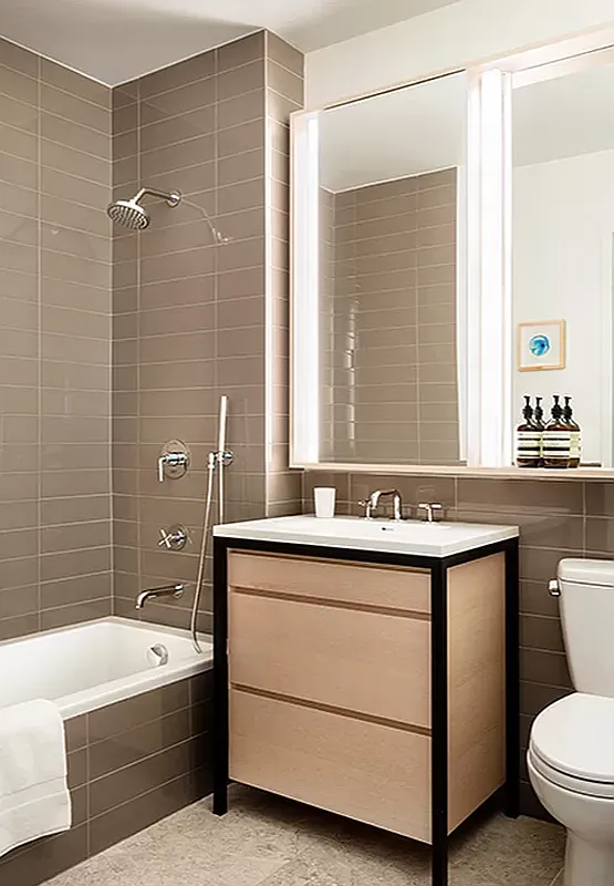 385 1st Avenue, Unit 11A Manhattan, NY 10010 - Photo 3 of 11 a bathroom with a sink double vanity mirror and a bathtub