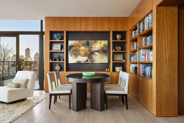 a living room with furniture a rug and a large window