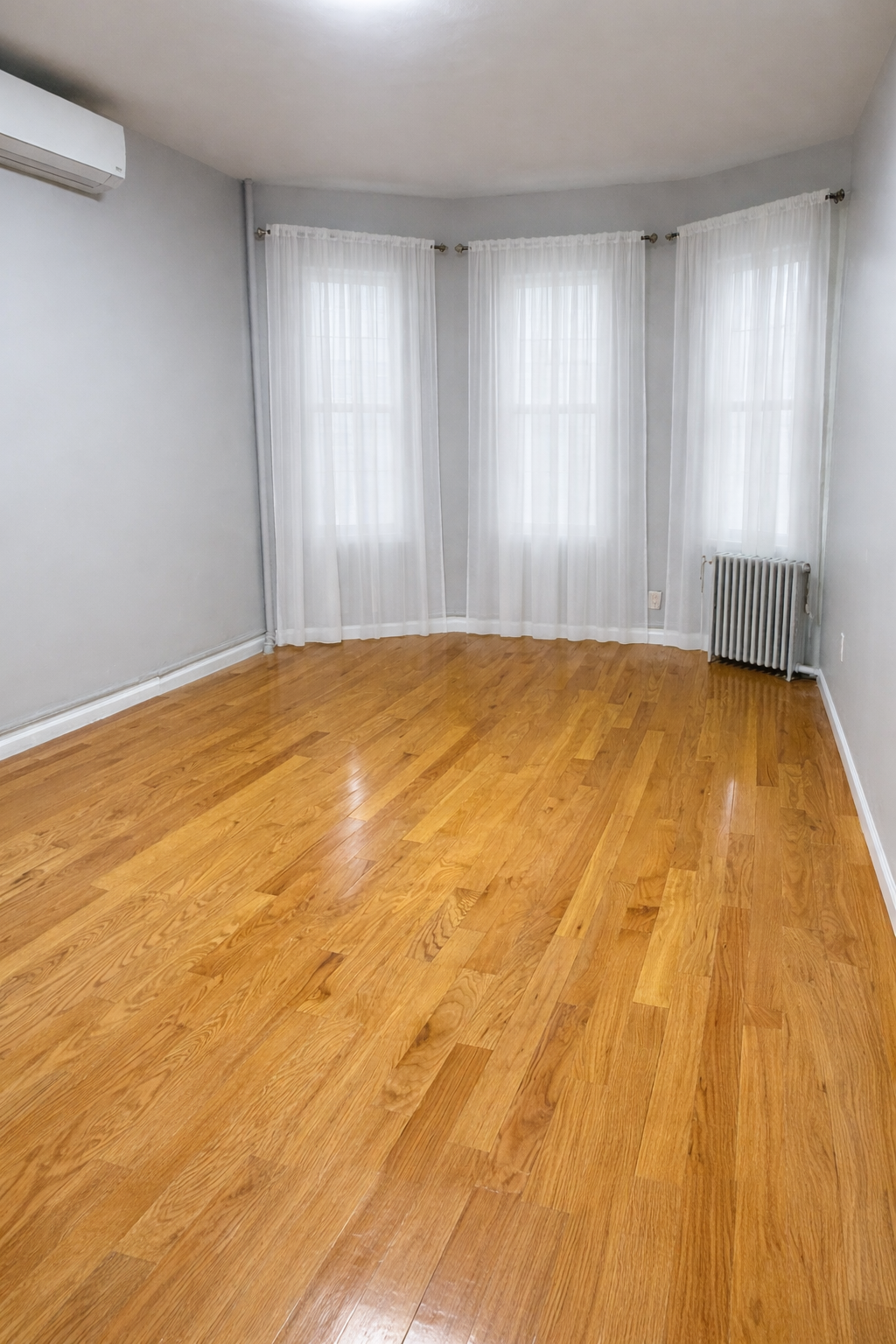 641 East 4th Street, Unit 1 Brooklyn, NY 11218 - Photo 5 of 15 a view of empty room with wooden floor and fan