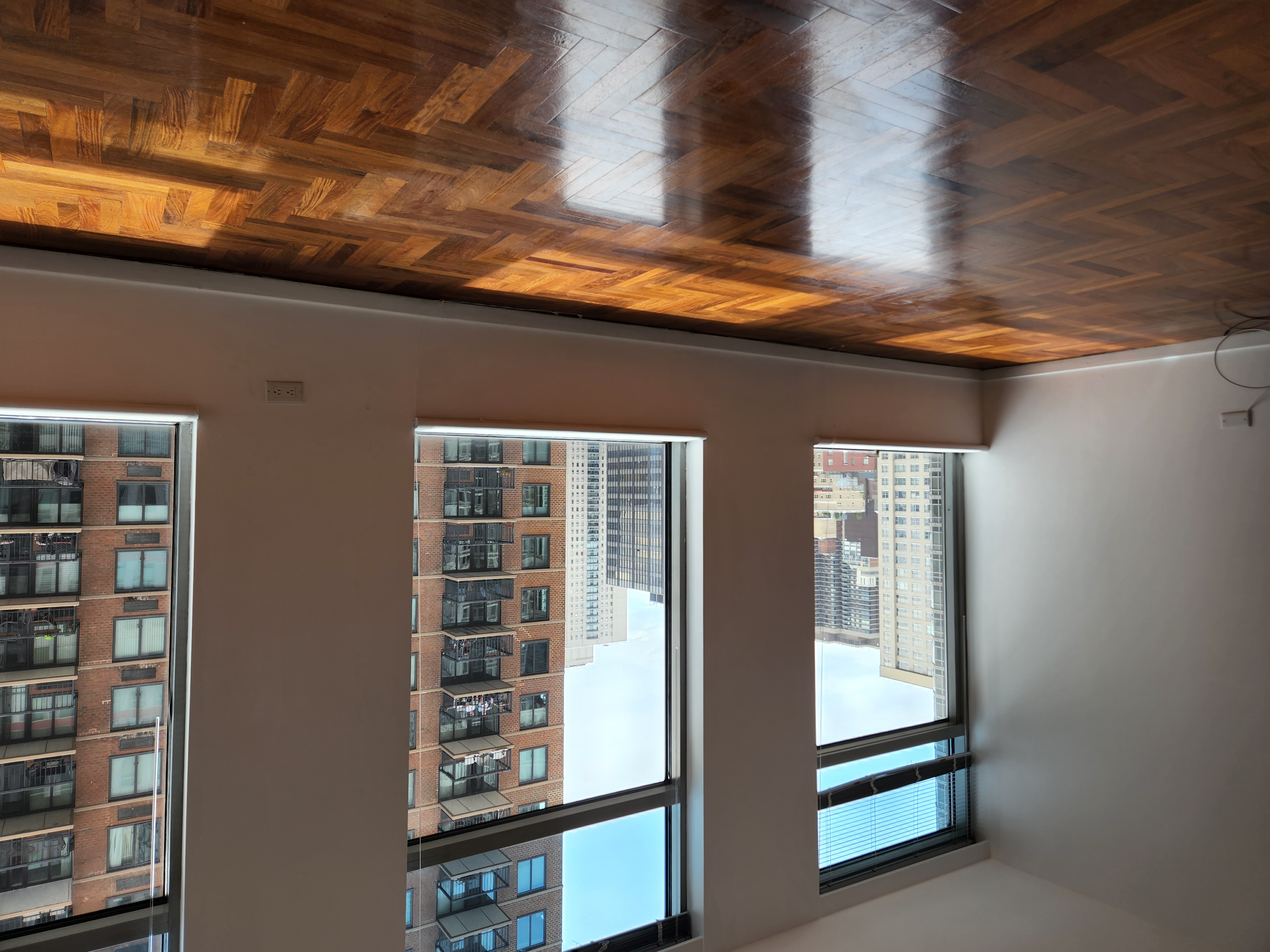 250 East 54th Street, Unit 14E Manhattan, NY 10022 - Photo 4 of 5 a view of an empty room with window and wooden floor