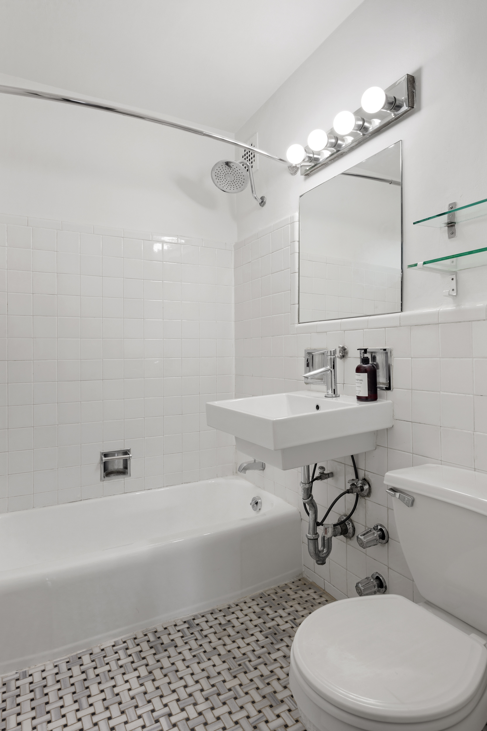 140 7th Avenue, Unit 4L Manhattan, NY 10011 - Photo 13 of 14 a bathroom with a sink a toilet and shower