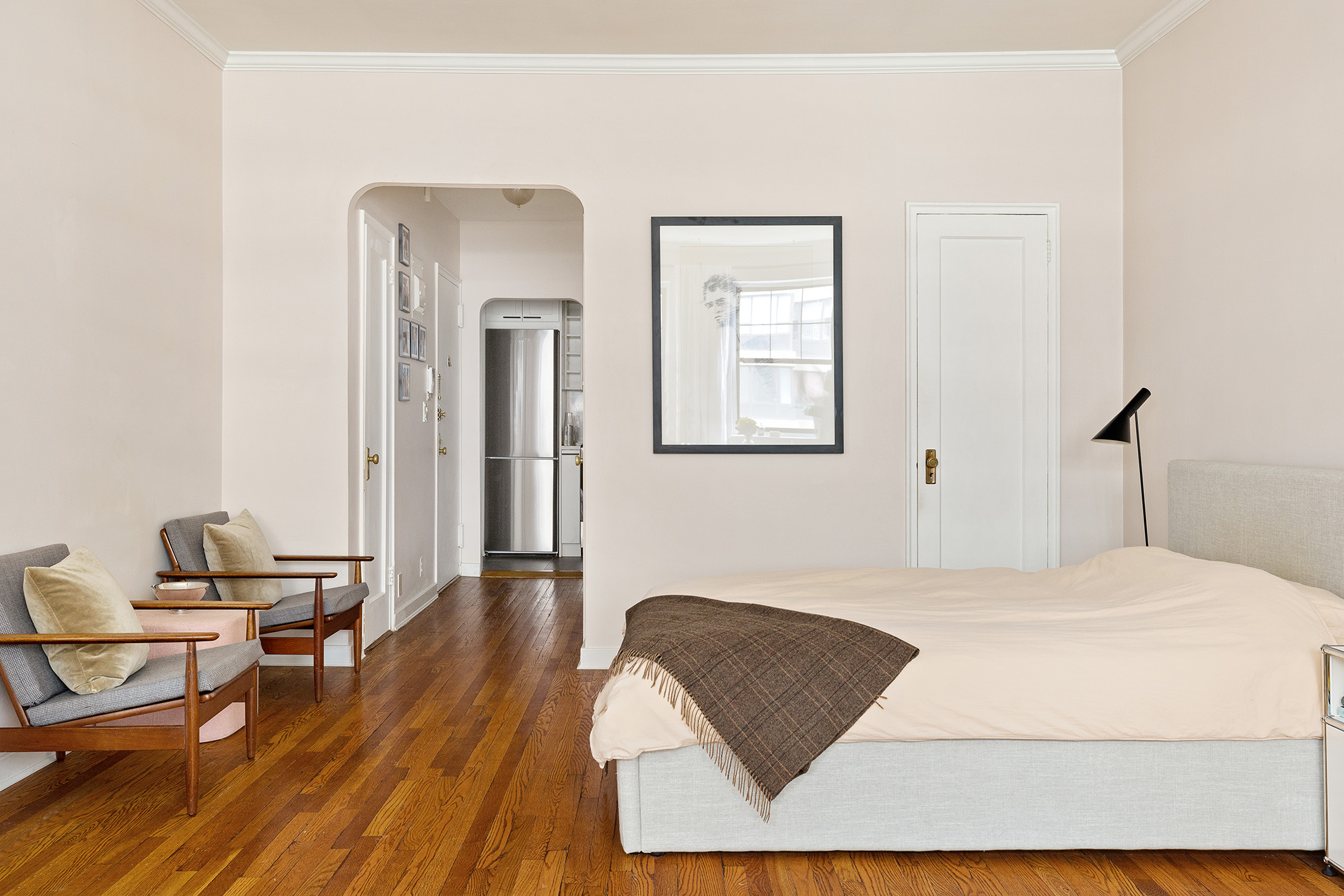434 East 58th Street, Unit 6B Manhattan, NY 10022 - Photo 2 of 6 a bedroom with a bed and wooden floor