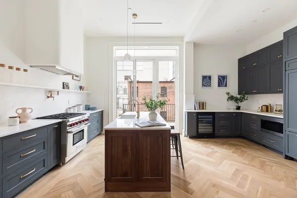 a kitchen with stainless steel appliances granite countertop a sink a stove and a refrigerator