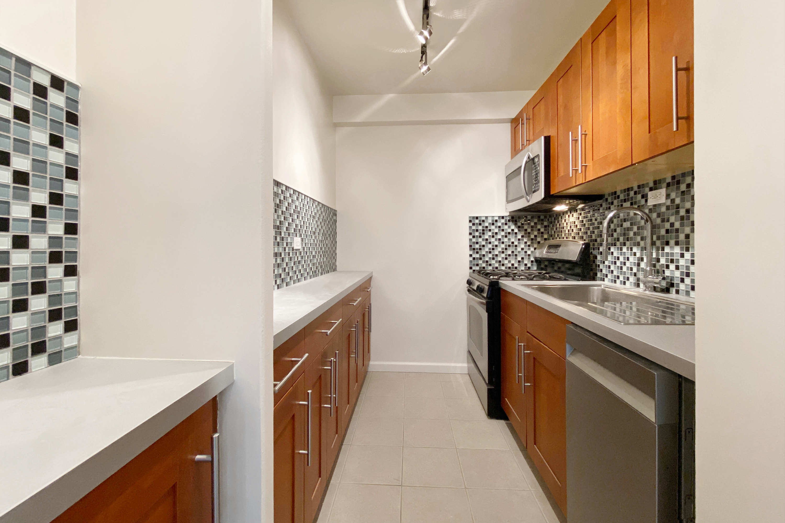 343 East 30th Street, Unit 16D Manhattan, NY 10016 - Photo 6 of 17 a kitchen with stainless steel appliances granite countertop a sink stove and refrigerator