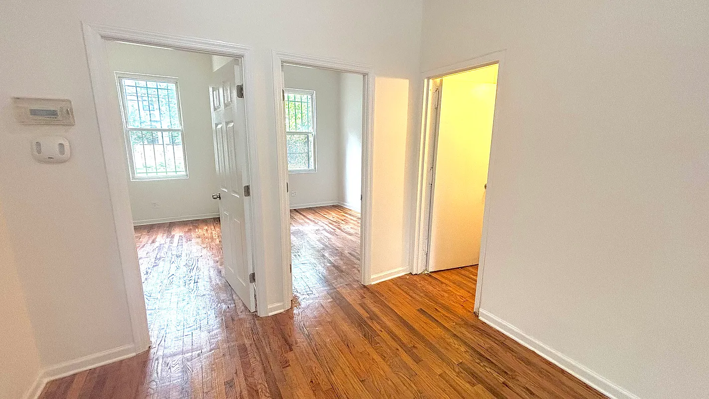 918 Dekalb Avenue, Unit 1 Brooklyn, NY 11221 - Photo 3 of 11 a view of empty room with wooden floor and fan