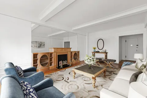 a living room with furniture a fireplace and white walls