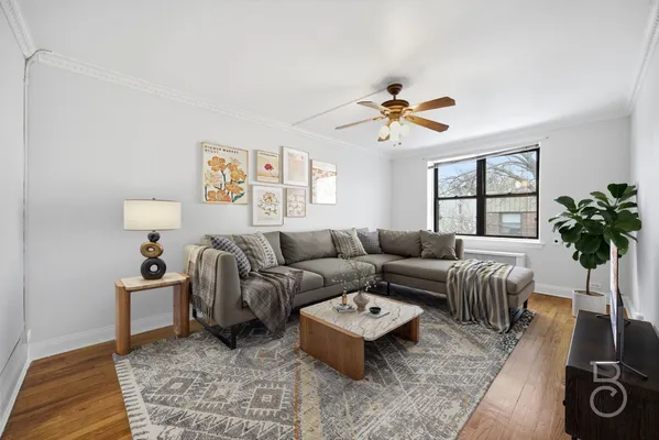 a living room with furniture a chandelier and a window