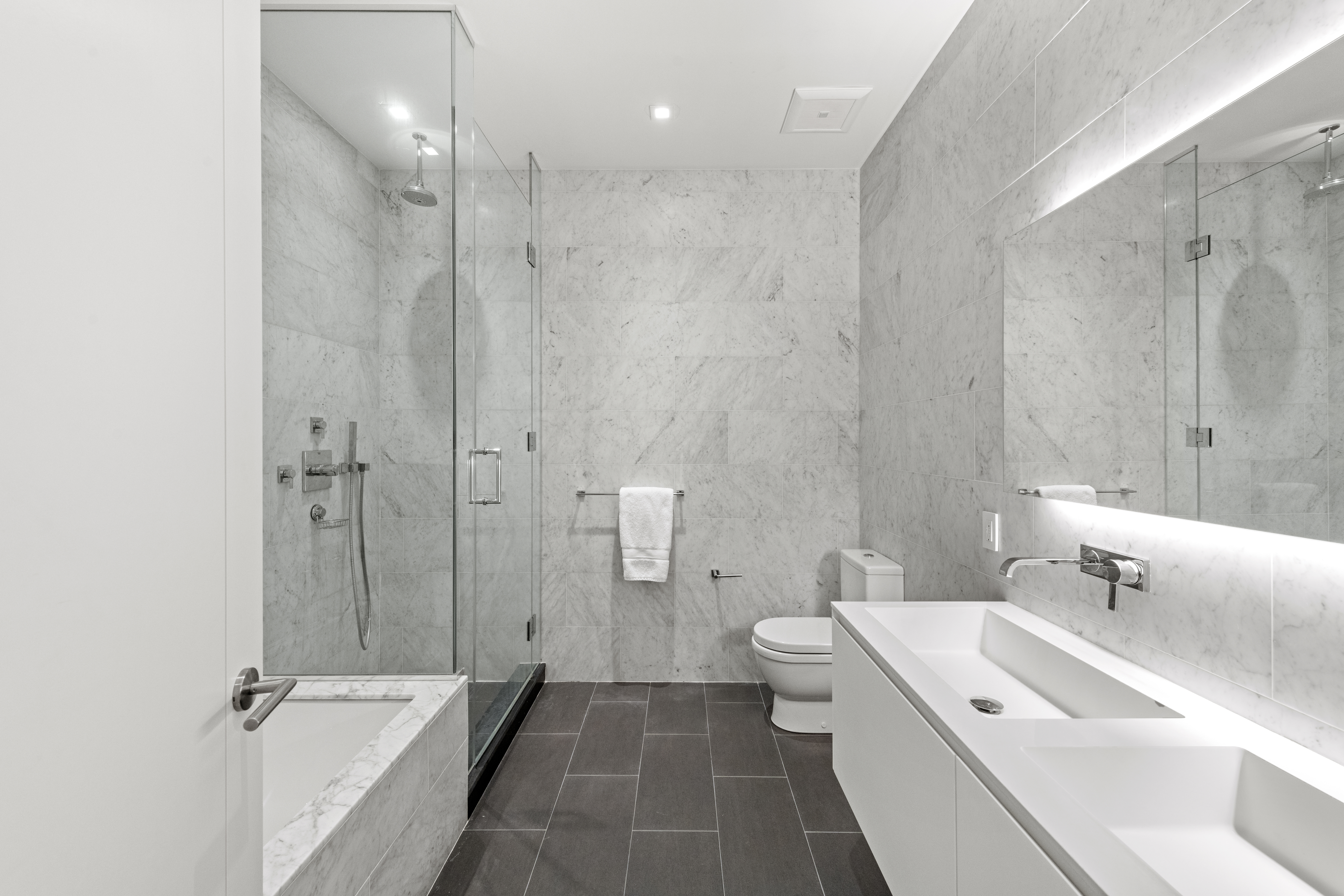 11 North Moore Street, Unit 2B Manhattan, NY 10013 - Photo 6 of 12 a bathroom with a double vanity sink a toilet and shower