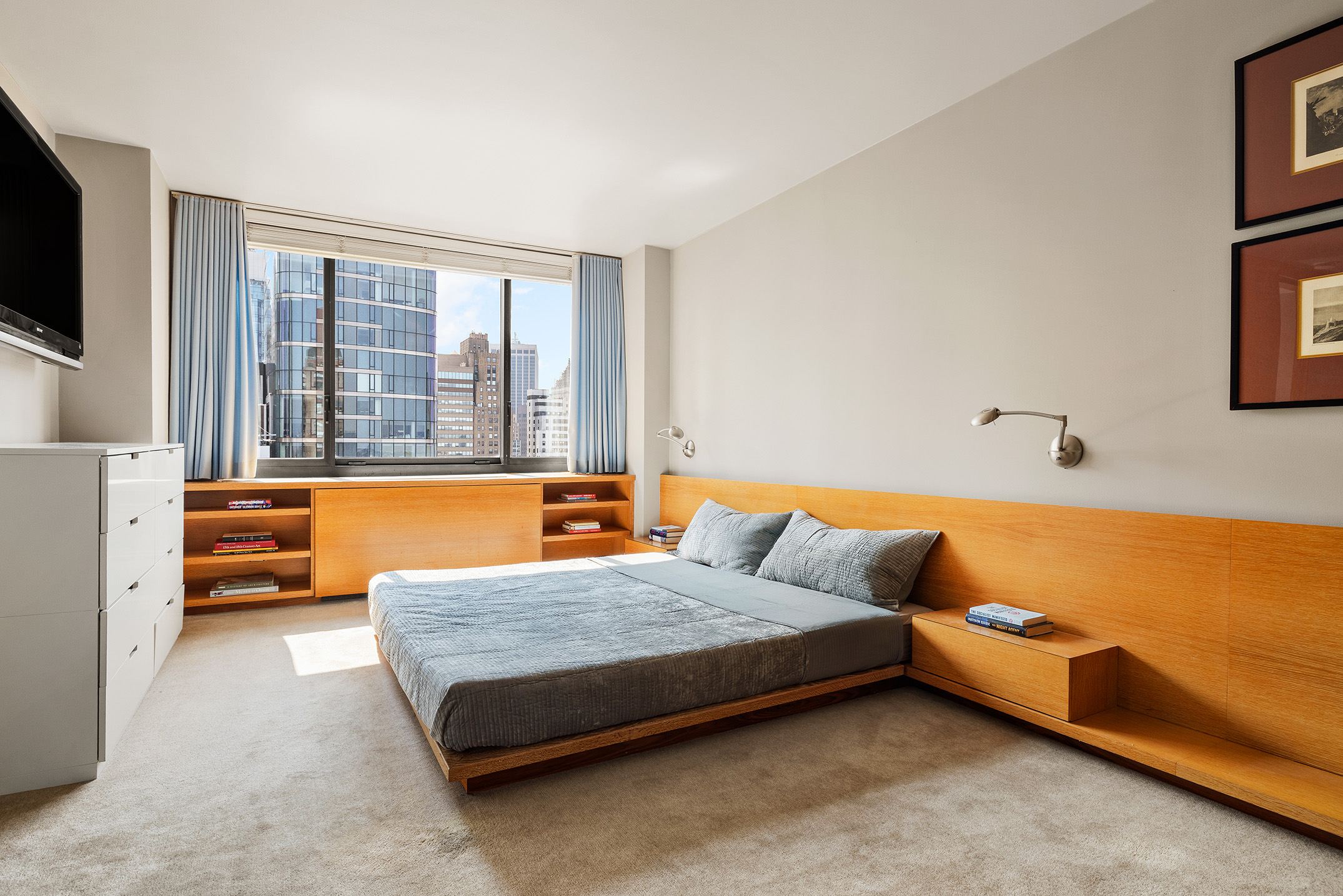 200 Rector Place, Unit 36LM Manhattan, NY 10280 - Photo 9 of 15 a bedroom with furniture and a flat screen tv