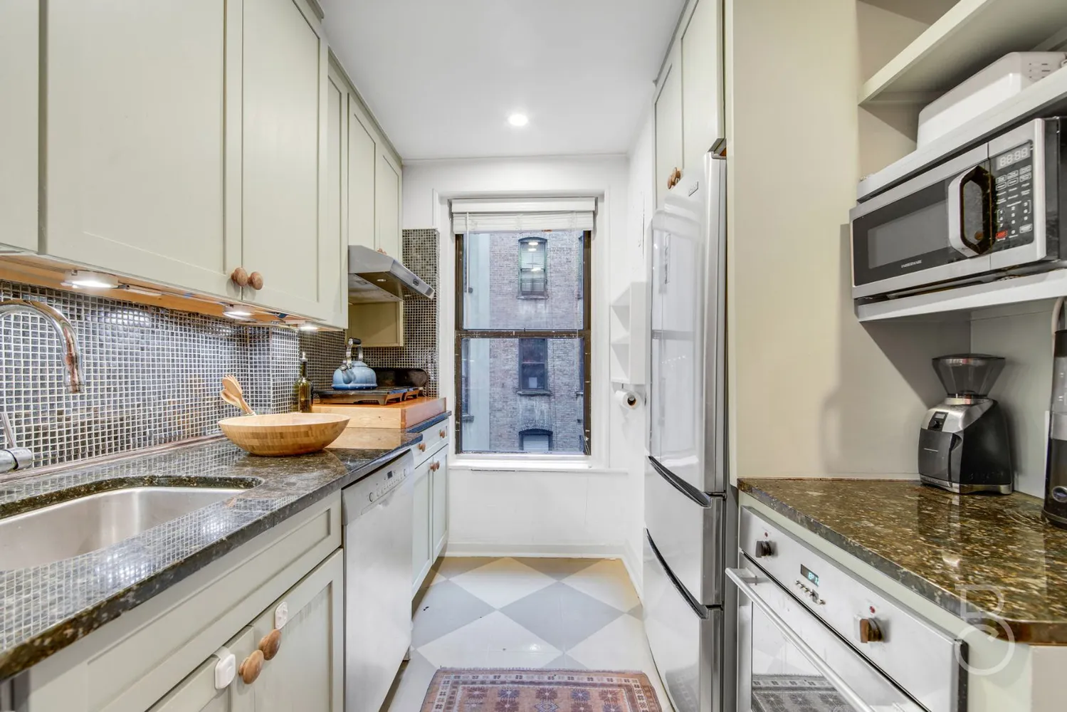 a kitchen with stainless steel appliances granite countertop a sink stove and cabinets