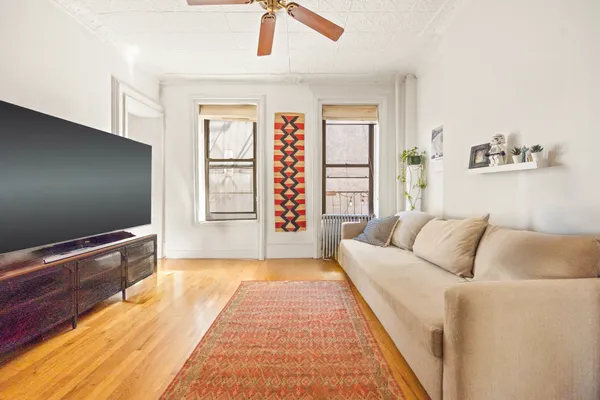 a bathroom with a sink a toilet a mirror and shower