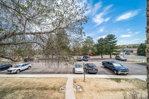 a view of a parking space with cars parked